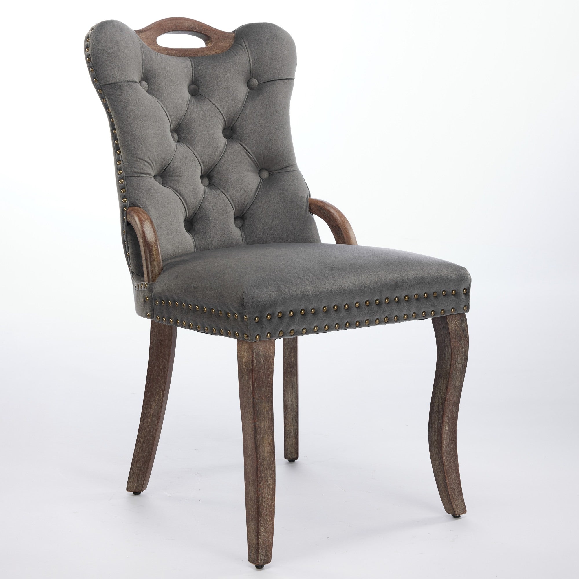 Elbe gray dining chair showing an angled front view with wood armrests and nailhead trim