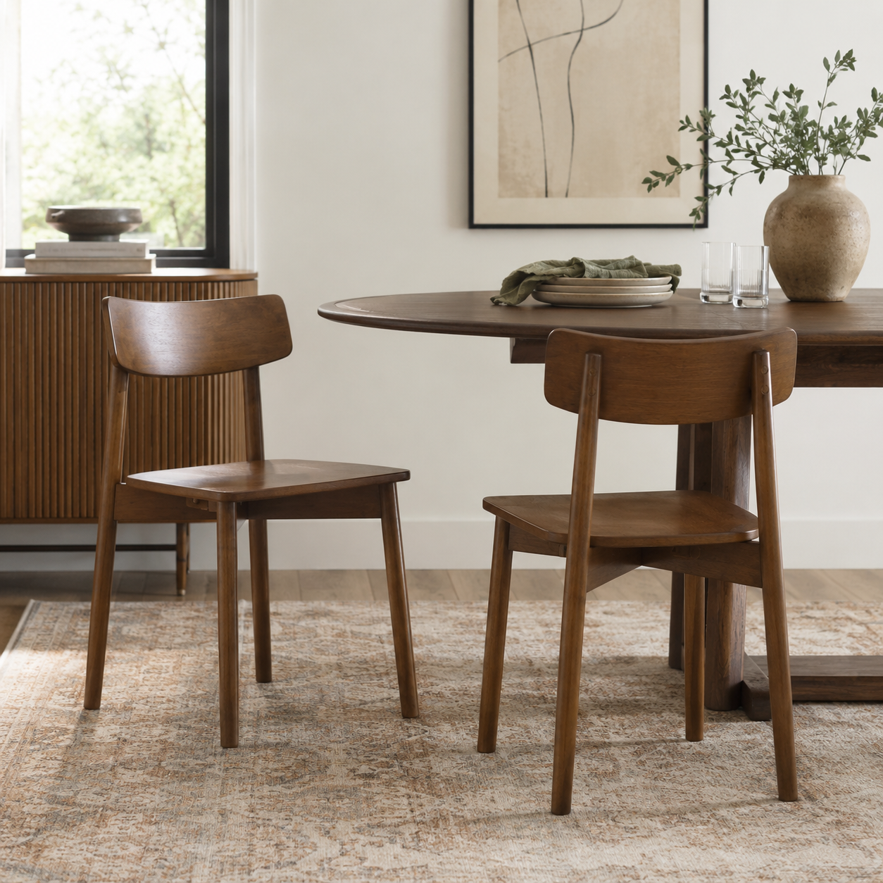 Euphrates brown solid wood dining chairs in a bright dining room with a round pedestal table