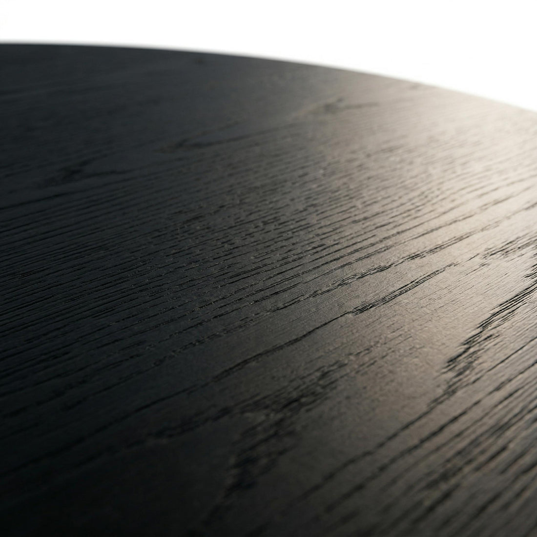 Genoa black coffee table close-up of the dark wood grain finish on the round tabletop