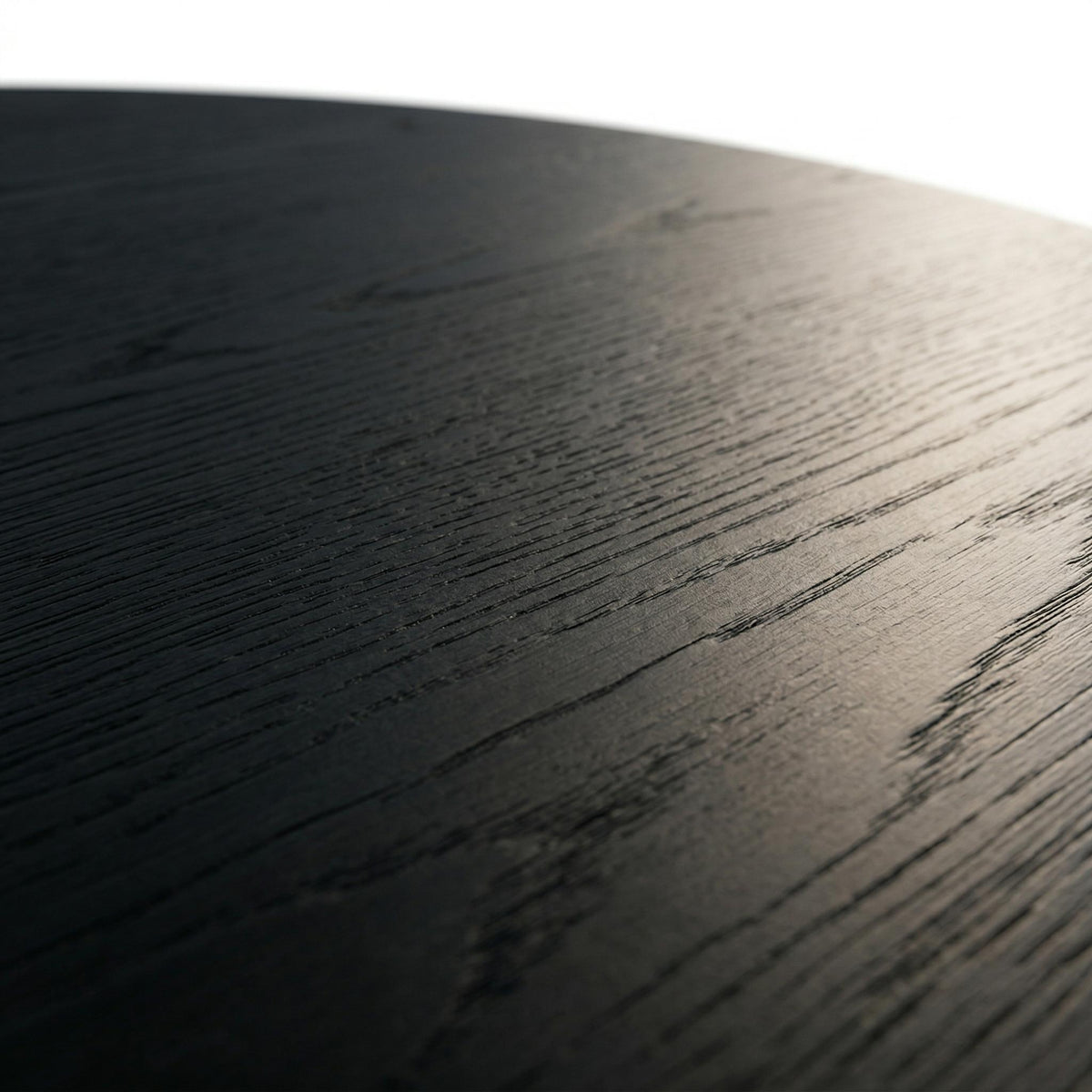 Genoa black coffee table close-up of the dark wood grain finish on the round tabletop