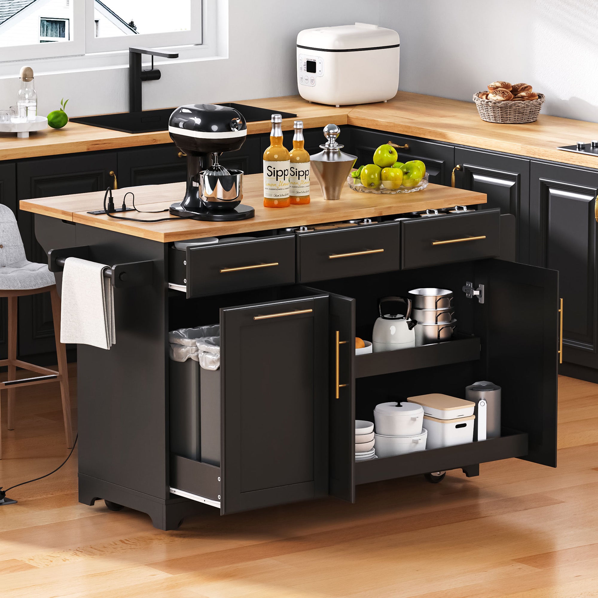 Honfleur black rolling kitchen island with open drawers hidden trash cabinet double shelf storage and expandable rubberwood countertop in kitchen setting