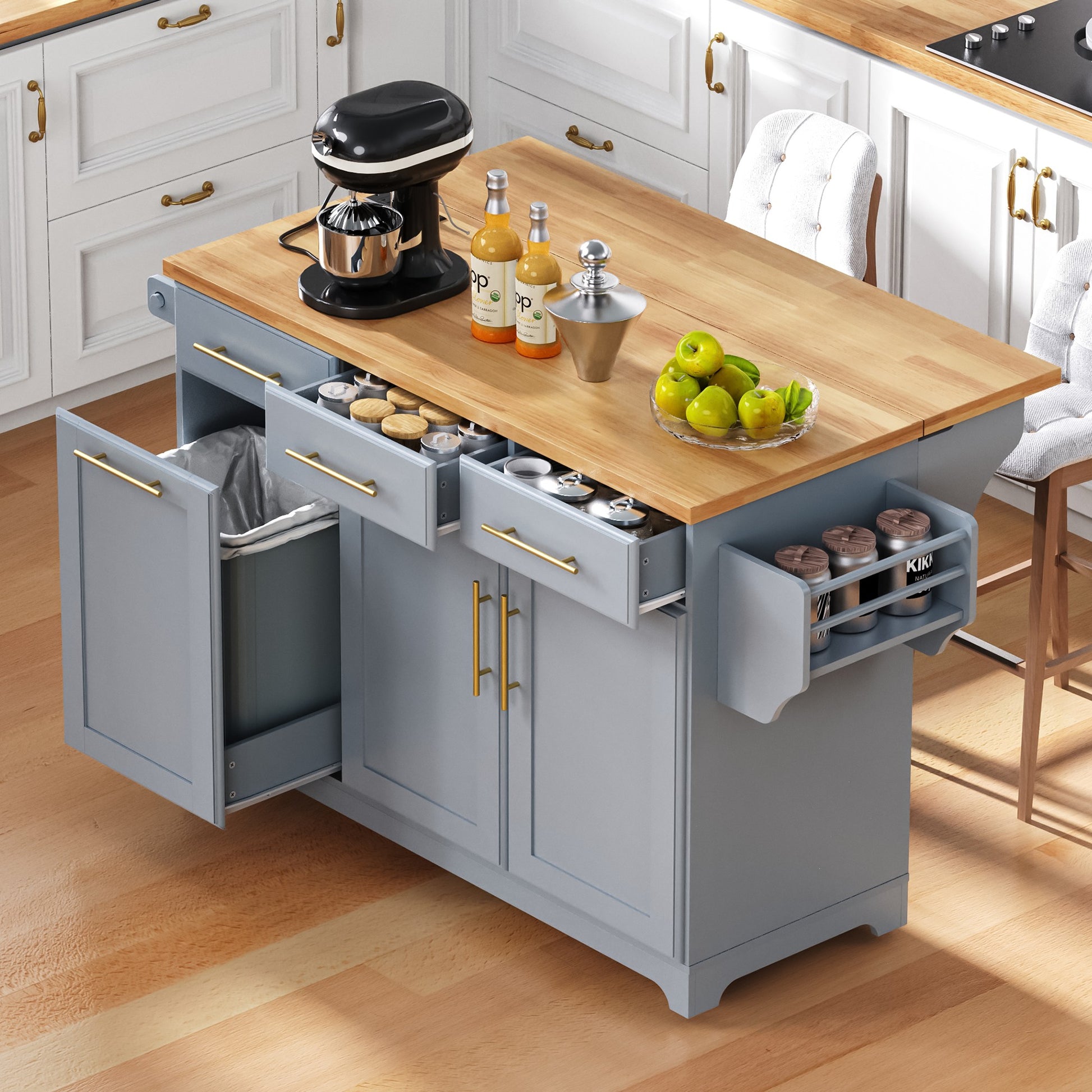 Honfleur gray rolling kitchen island with open spice drawers hidden trash cabinet and expandable rubberwood countertop in kitchen setting