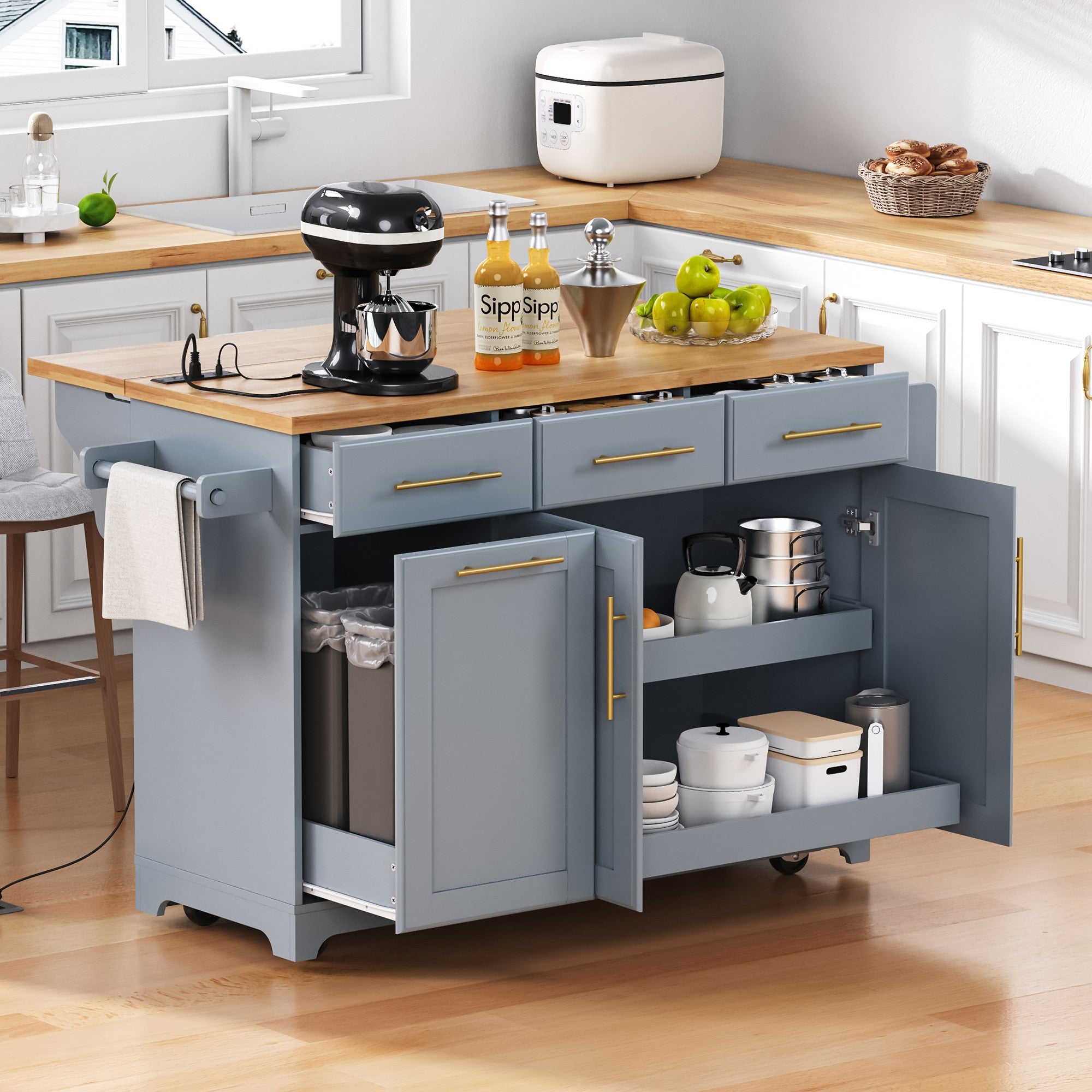 Honfleur gray rolling kitchen island with open drawers hidden trash cabinet double shelf storage and expandable rubberwood countertop in kitchen setting