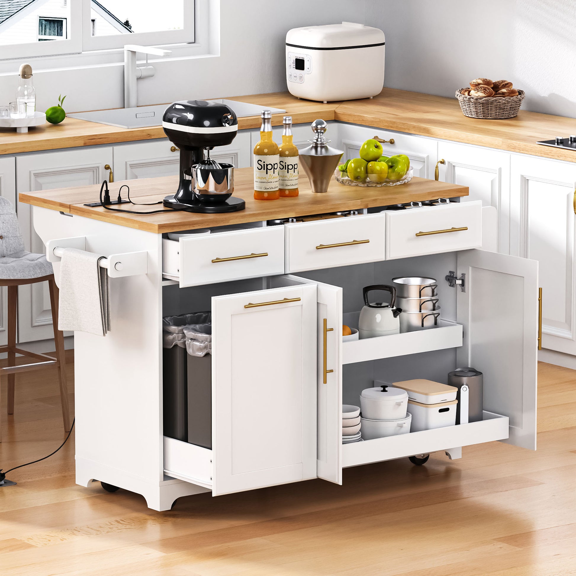 Honfleur white rolling kitchen island with rubberwood countertop open cabinet storage pull-out shelves hidden trash bin and three drawers in kitchen setting