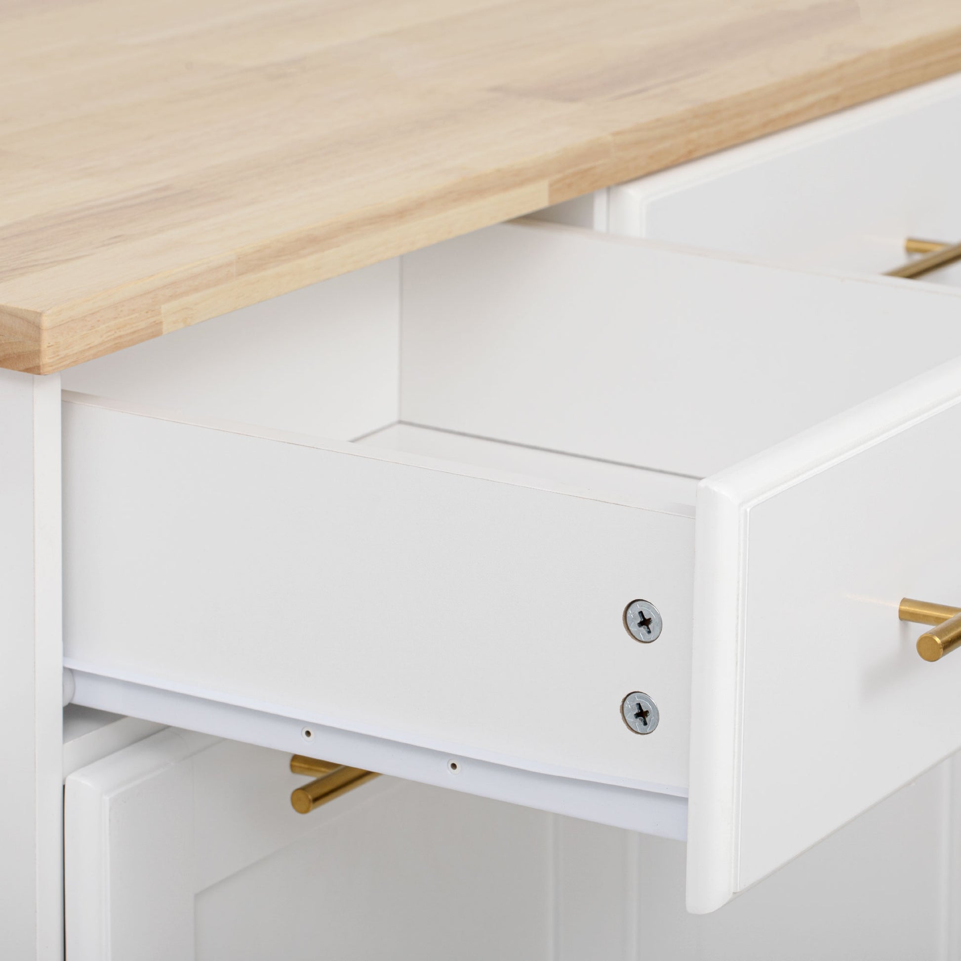 Honfleur rolling kitchen island drawer storage close-up with natural wood countertop in white finish on white background
