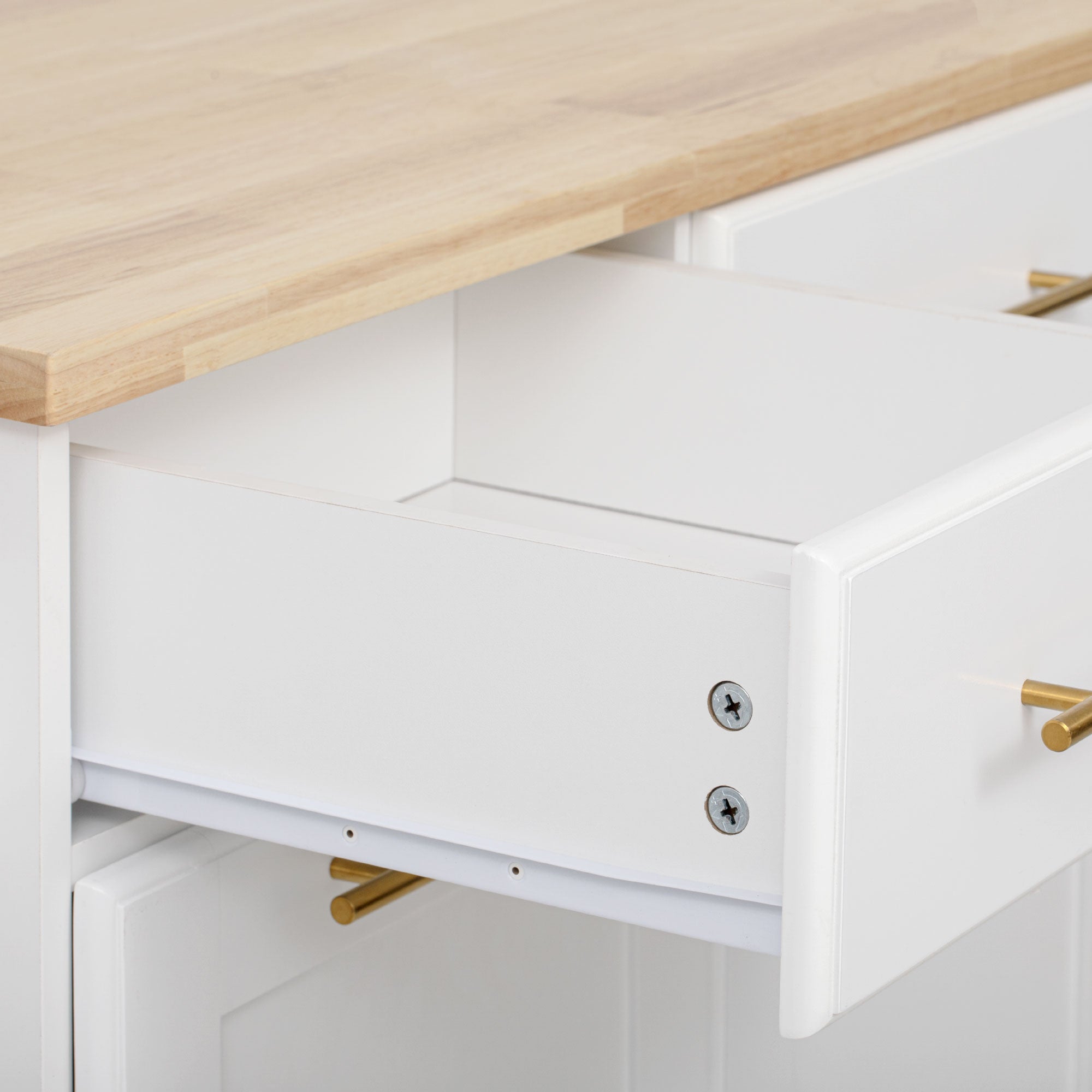Honfleur rolling kitchen island drawer storage close-up with natural wood countertop in white finish on white background