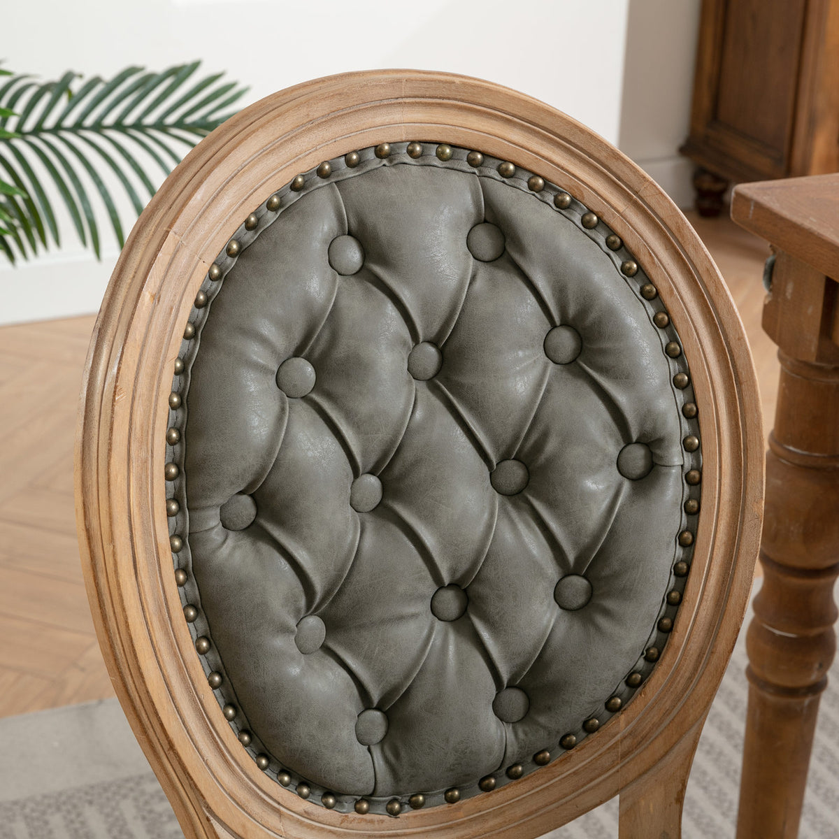 Iseo dark brown dining chair close-up of the oval button tufted backrest with solid rubberwood frame
