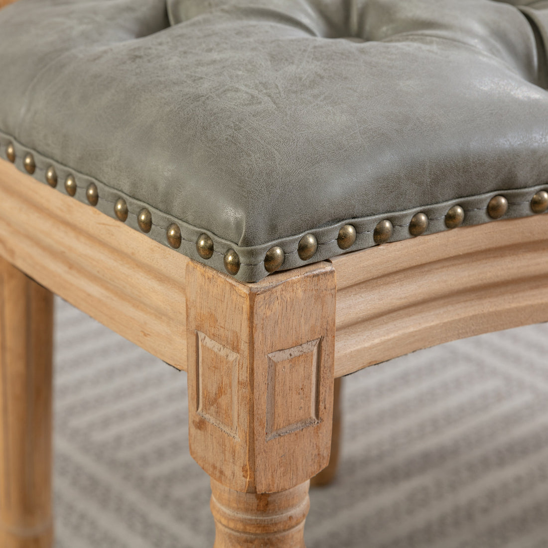 Iseo dark brown dining chair close-up of the upholstered seat edge and solid rubberwood frame