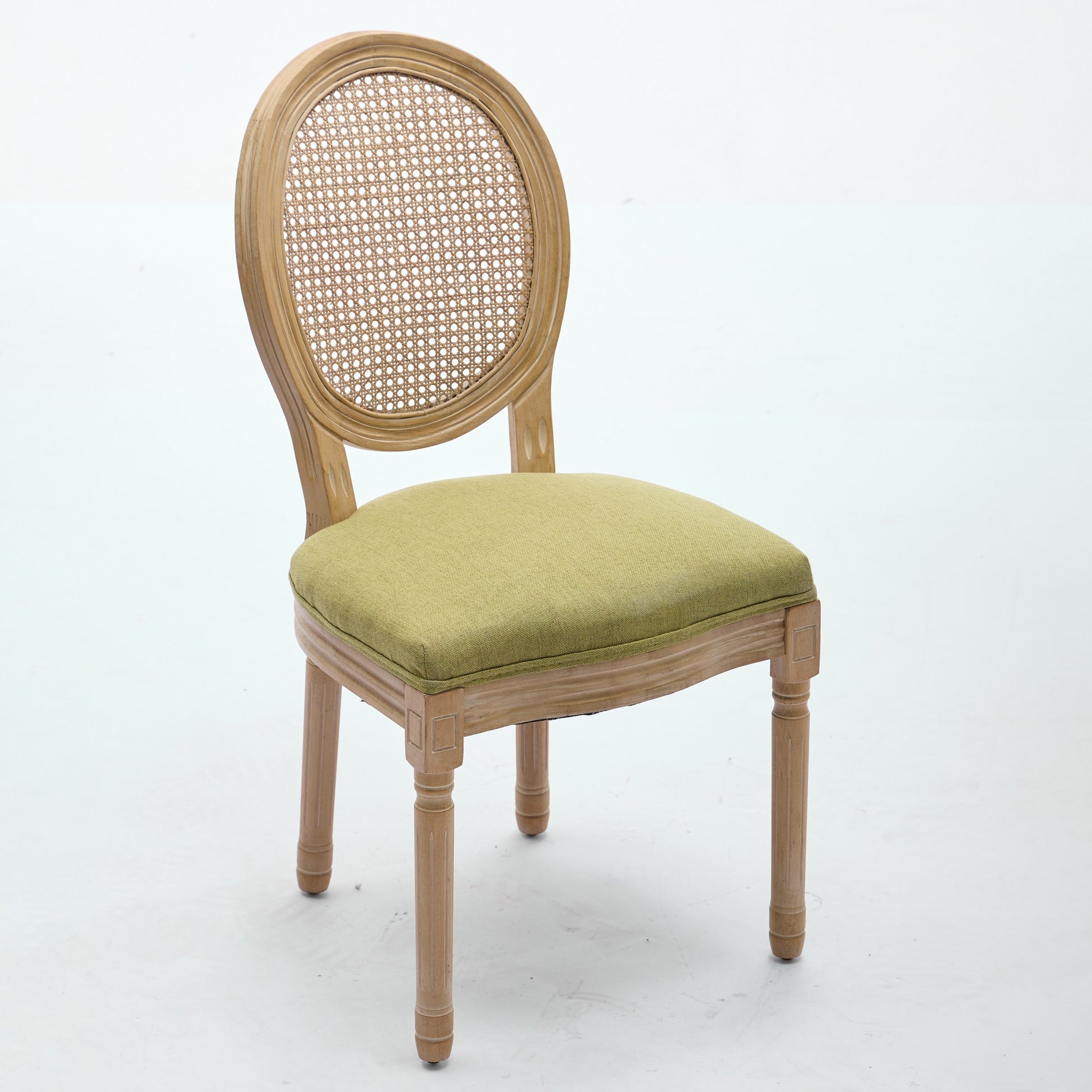 Iseo green dining chair front angled view with cane back and wood legs on white background