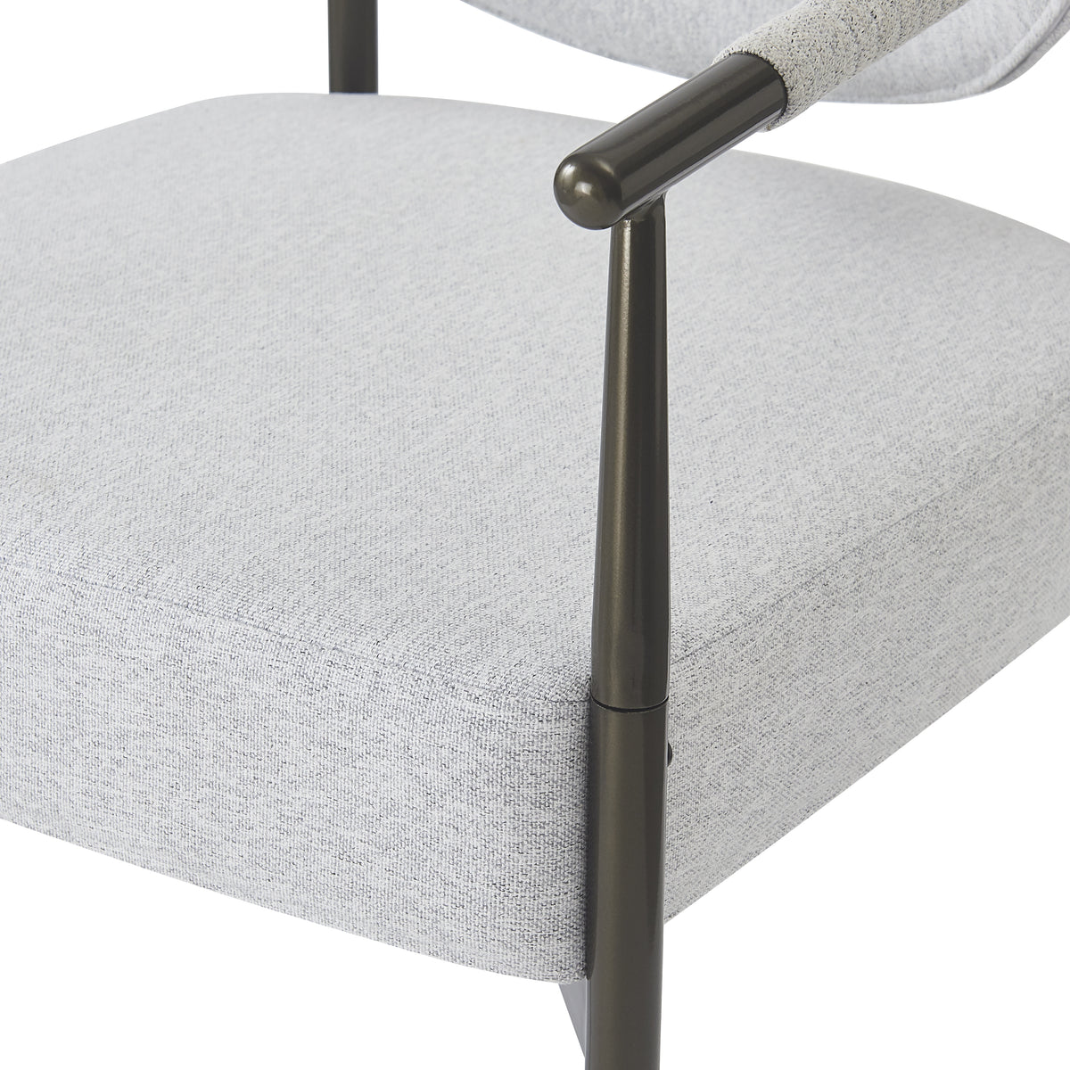 Kariba gray dining chair close-up of the slim metal frame beside the padded seat