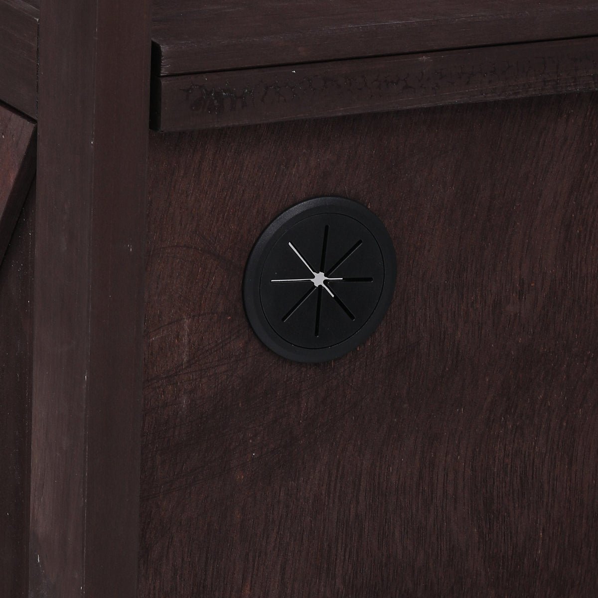 Close-up of the cable management hole on the black Limoges outdoor kitchen island designed for routing power cords and outdoor appliance connections inside the storage cabinet