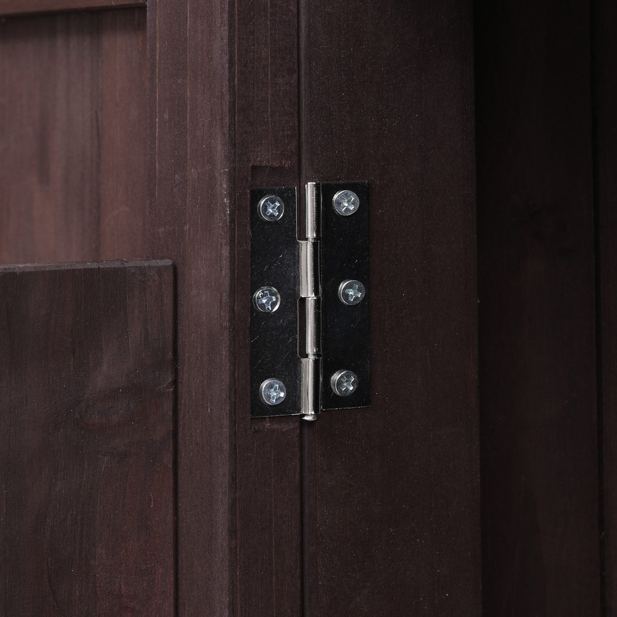 Close-up of the metal door hinge on the black Limoges outdoor kitchen island showing sturdy solid wood cabinet construction and durable hardware for outdoor storage use