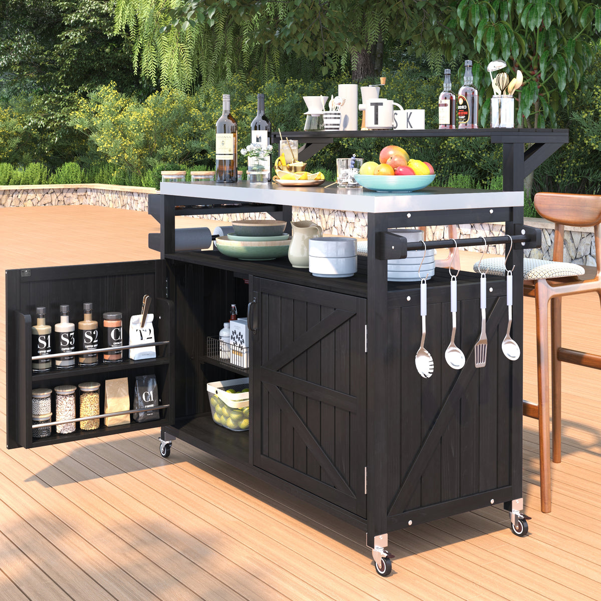Black Limoges rolling outdoor kitchen island with stainless steel countertop open cabinet storage spice rack utensil hooks and caster wheels styled on an outdoor patio deck