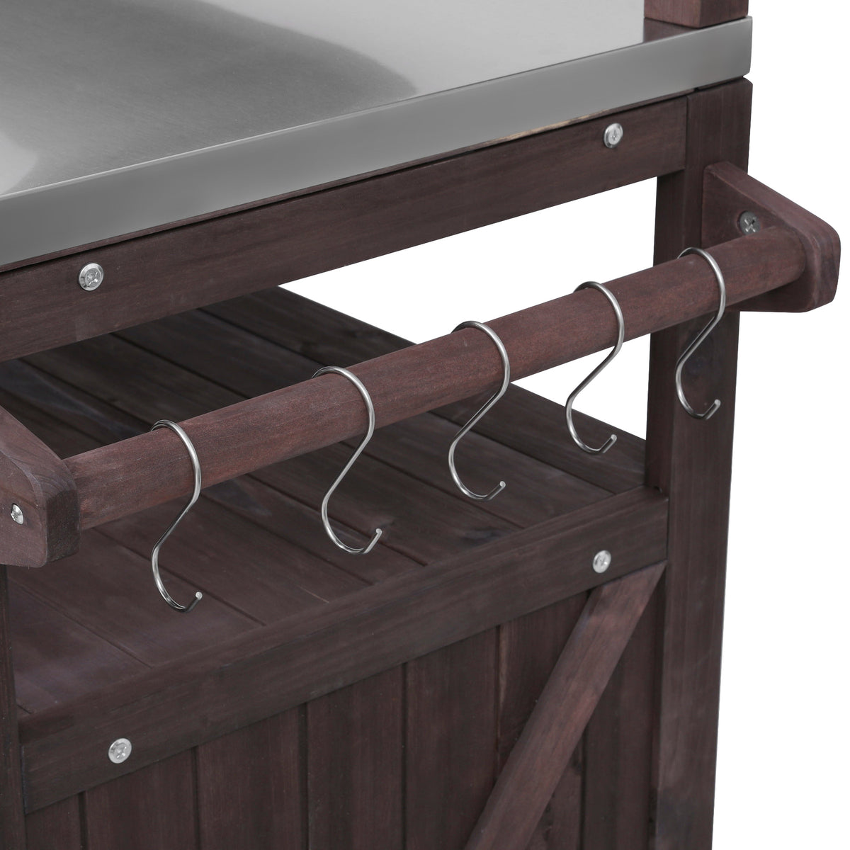 Close-up of the utensil hanging rod with metal hooks on the black Limoges outdoor kitchen island beside the stainless steel countertop for organizing grilling tools and cooking accessories