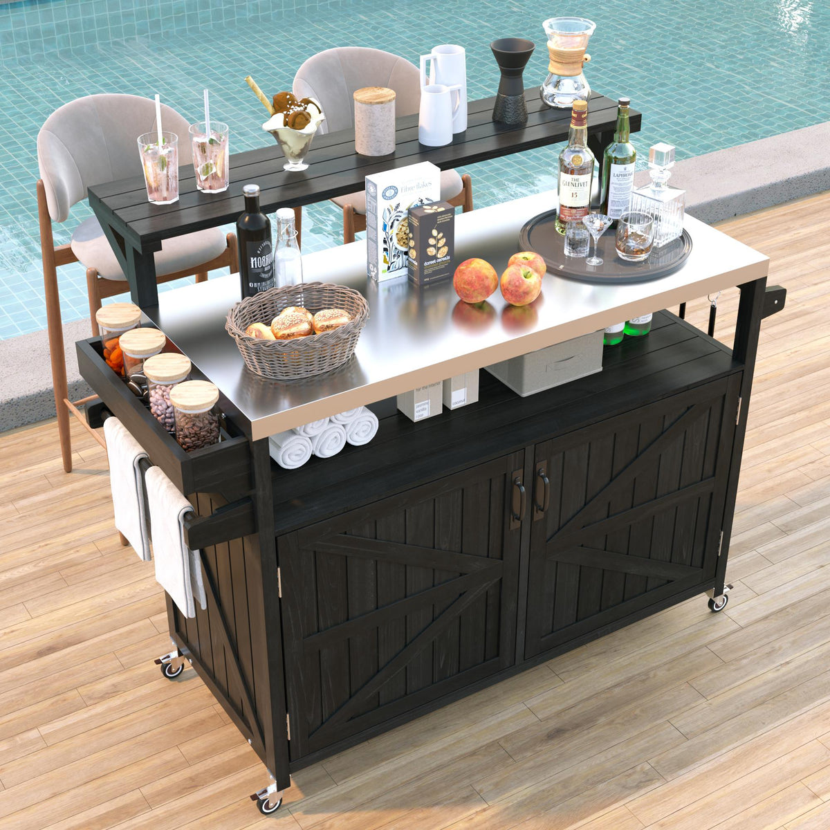 Black Limoges solid wood rolling outdoor kitchen island with stainless steel countertop raised shelf cabinet storage and towel rack beside a swimming pool patio seating area