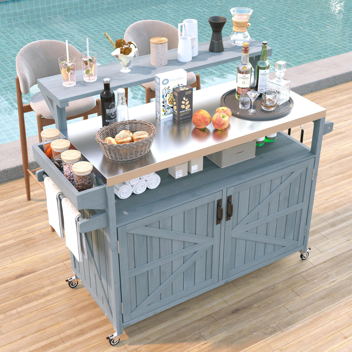 Gray blue Limoges solid wood rolling outdoor kitchen island with stainless steel top raised shelf spice rack and storage cabinet styled beside a pool for outdoor entertaining and grilling prep
