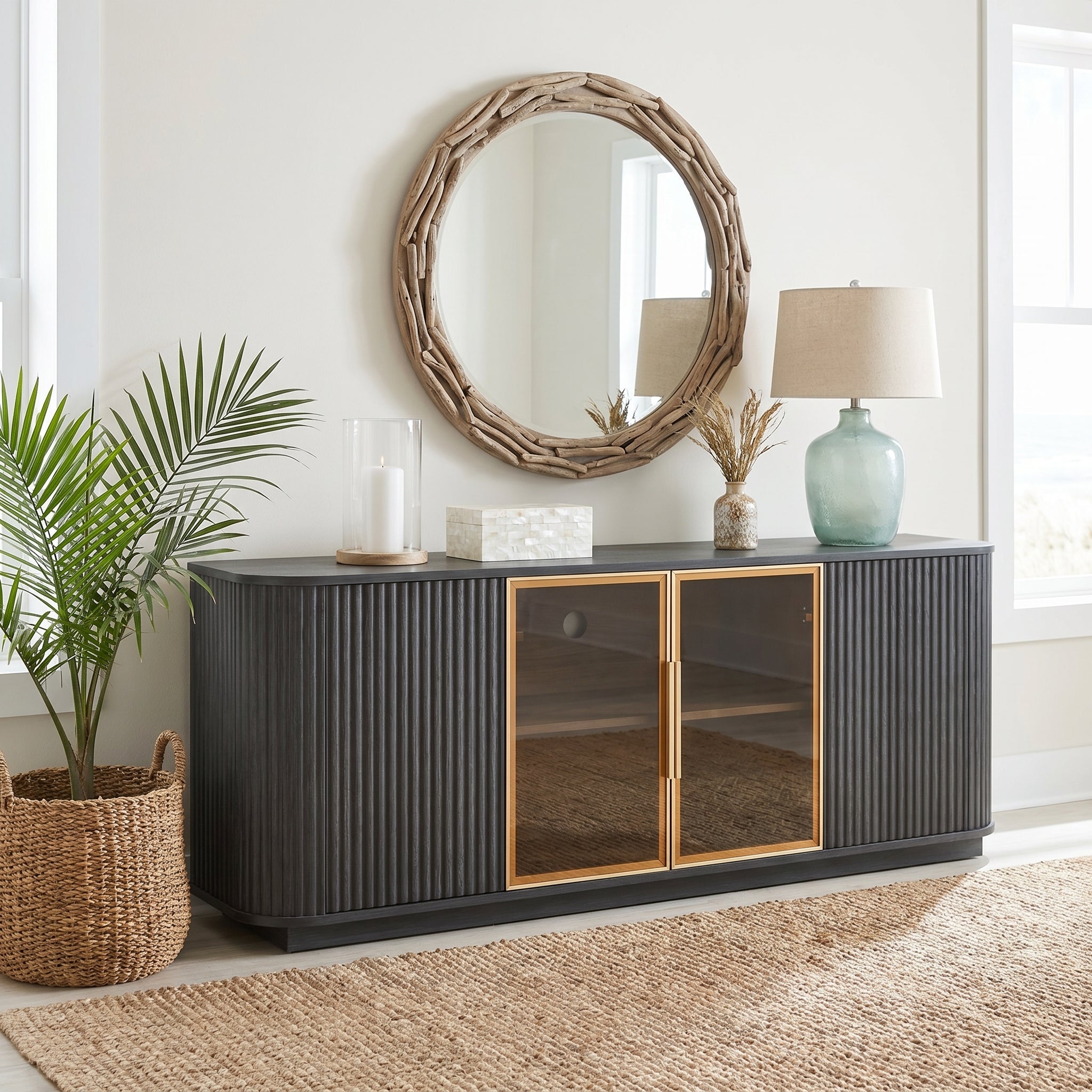 Lund black tv stand showing a styled cabinet below a round wall mirror