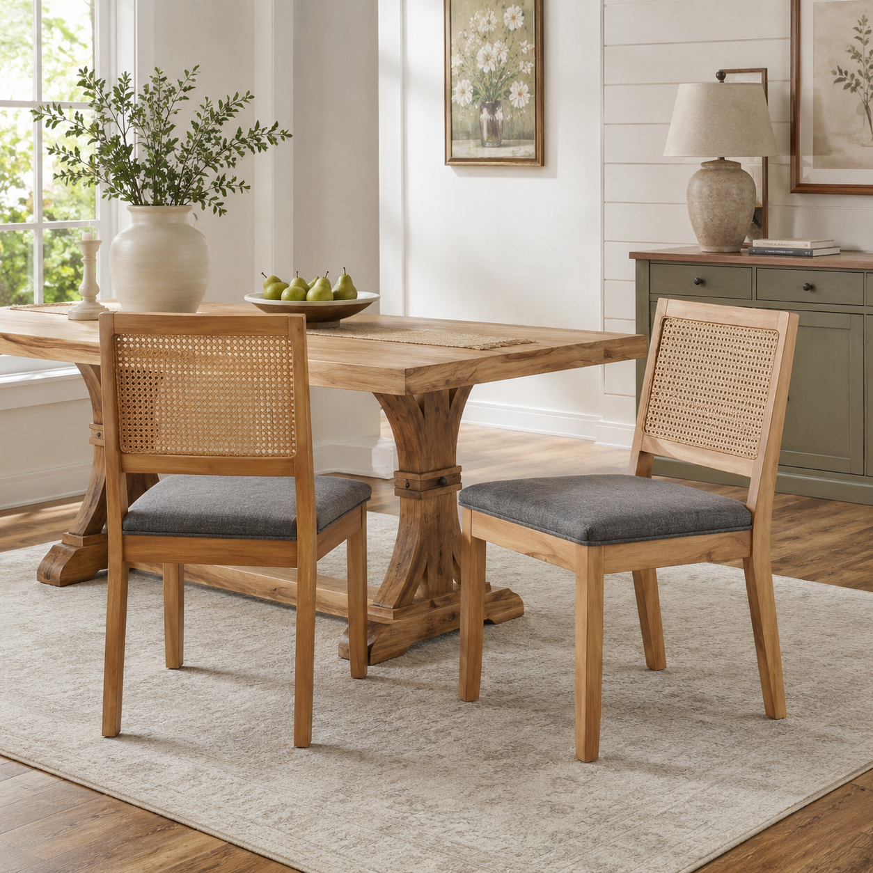 Maggiore gray rattan dining chairs beside a round wood table in a warm neutral dining space