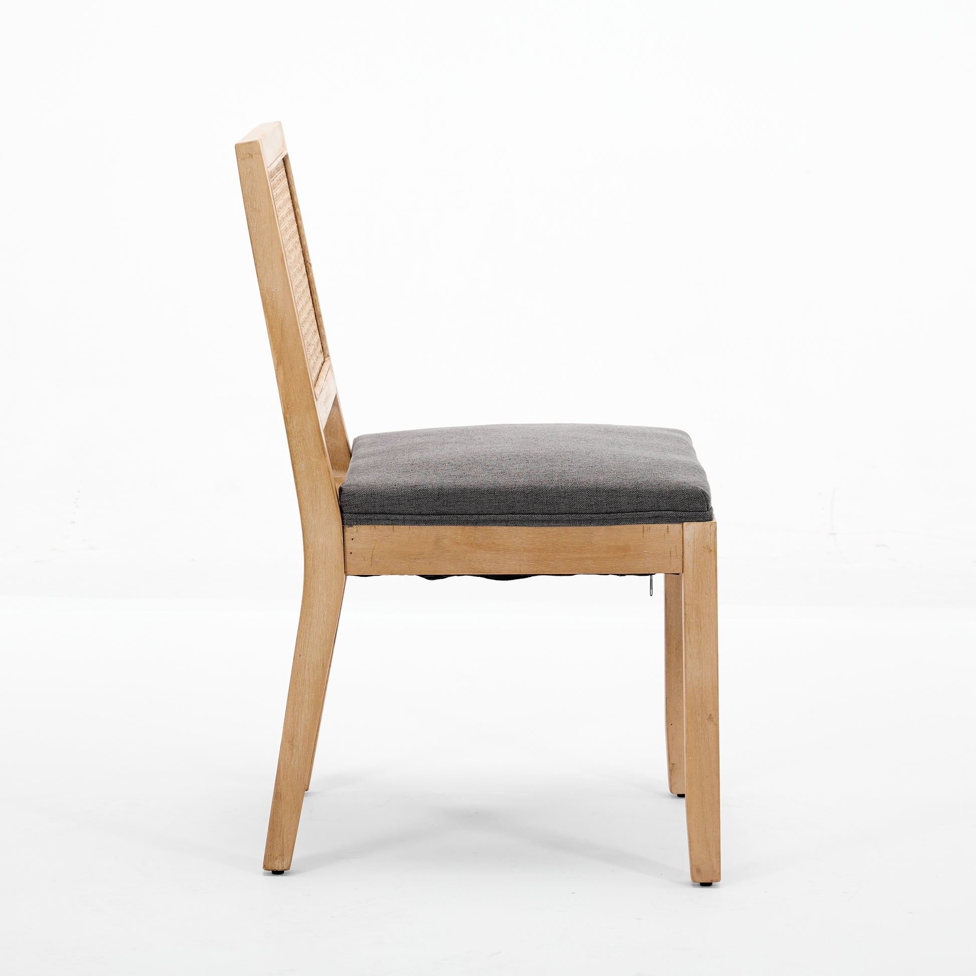 Maggiore gray rattan dining chair side view with solid rubberwood legs on white background