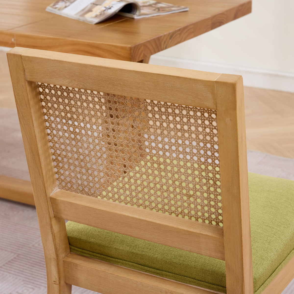 Maggiore green dining chair close-up of the woven rattan backrest and upholstered seat