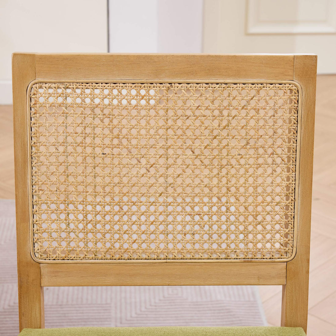 Maggiore green dining chair close-up of the handwoven rattan backrest