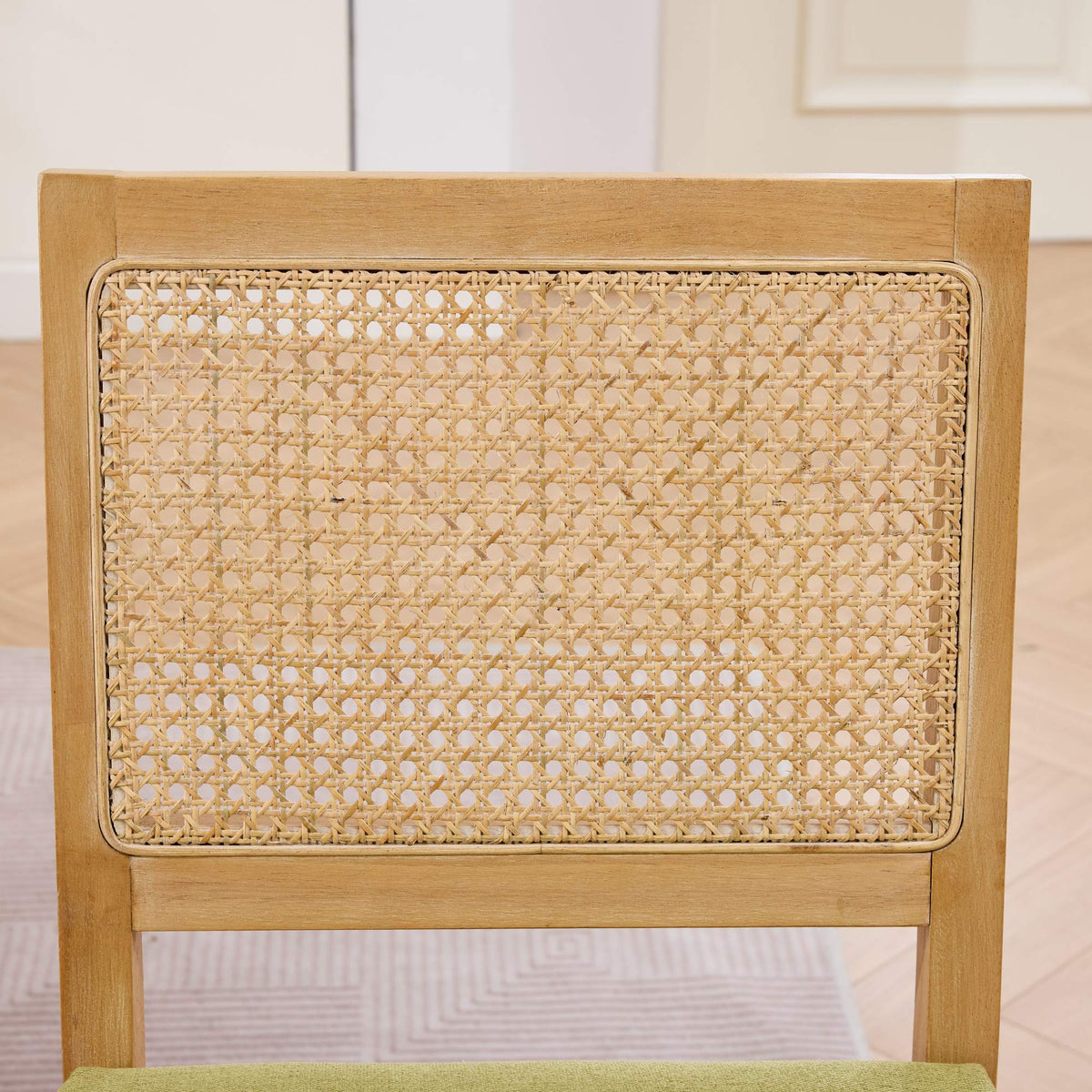 Maggiore green dining chair close-up of the handwoven rattan backrest