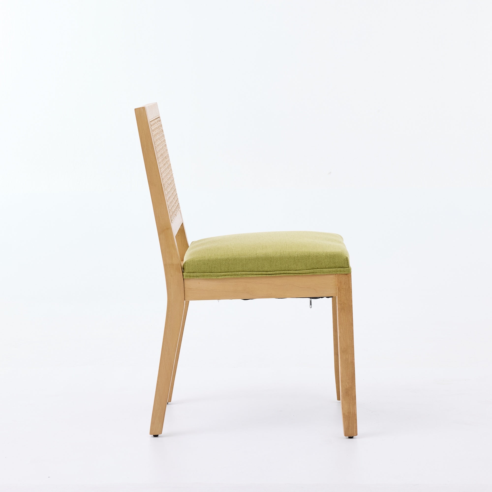 Maggiore green rattan dining chair side view with solid wood legs on white background