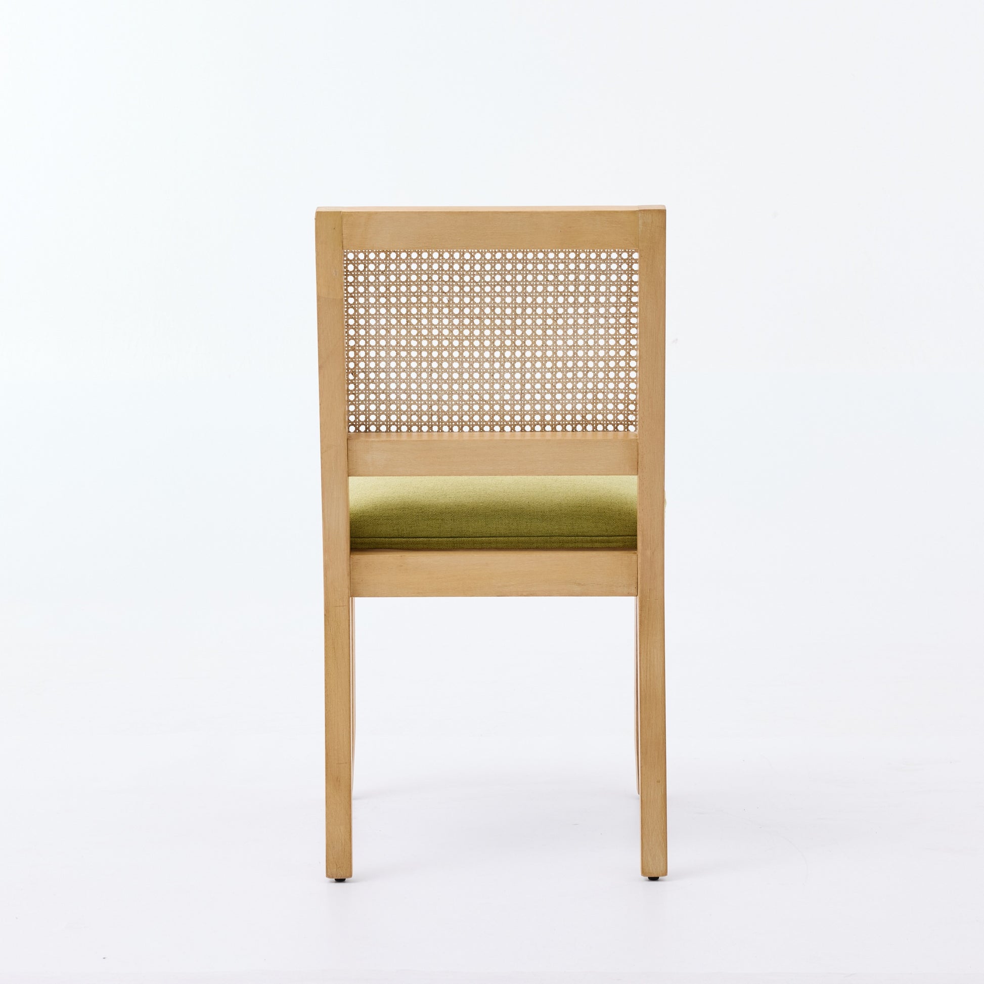 Maggiore green dining chair rear view showing woven rattan backrest on white background