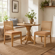 Maggiore orange dining chairs with woven rattan backs in a bright contemporary dining room