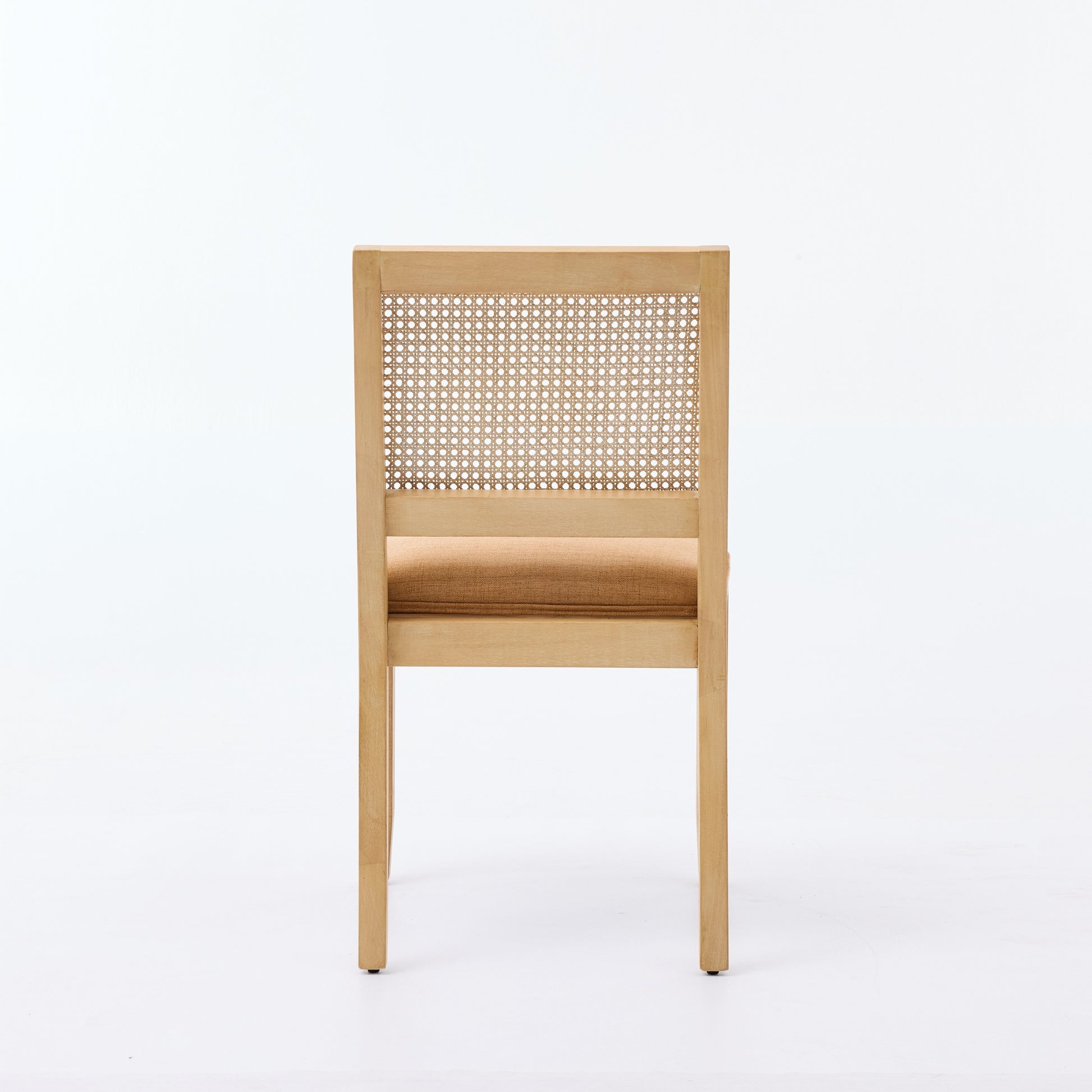 Maggiore orange dining chair rear view with woven rattan backrest on white background