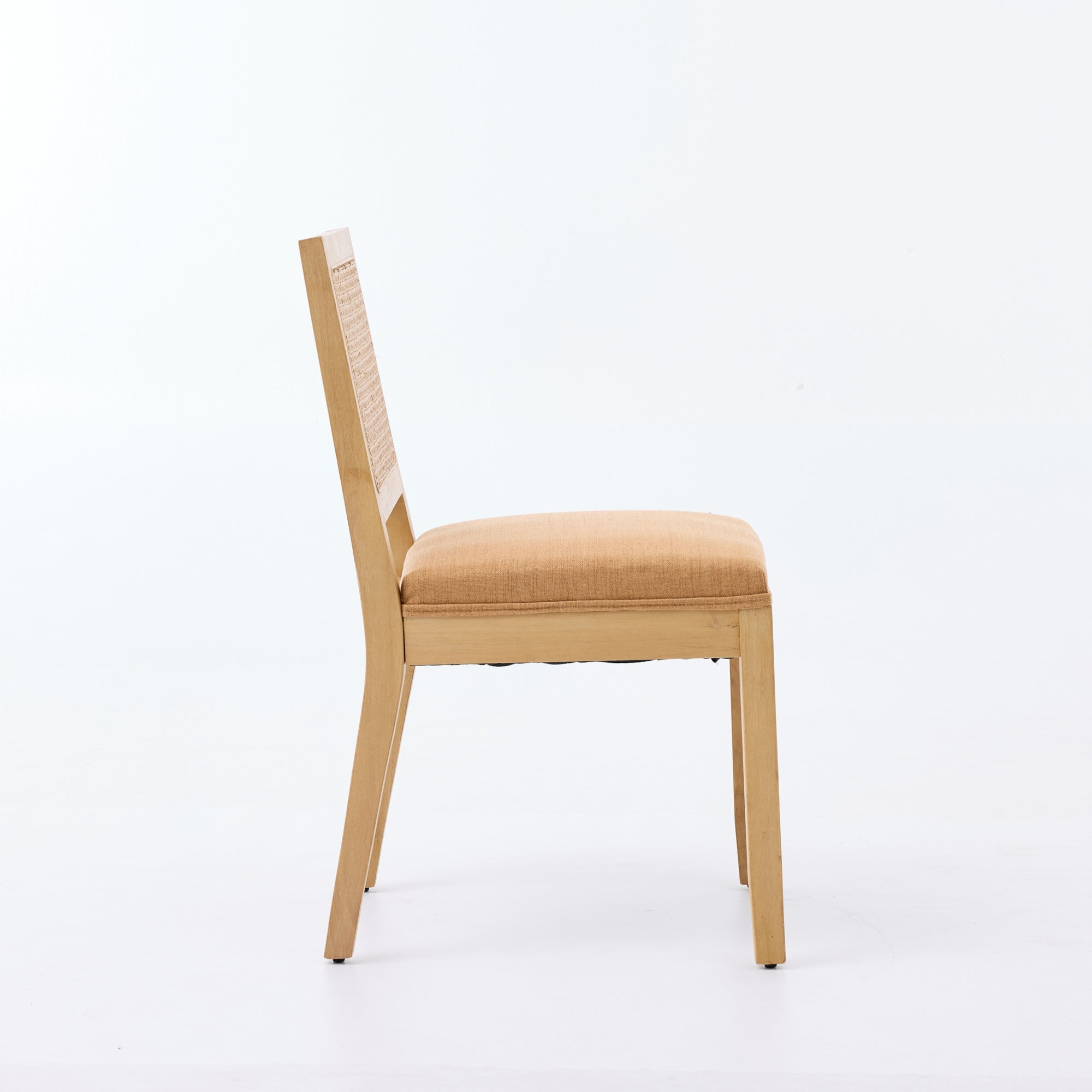 Maggiore orange rattan dining chair side view with solid rubberwood legs on white background