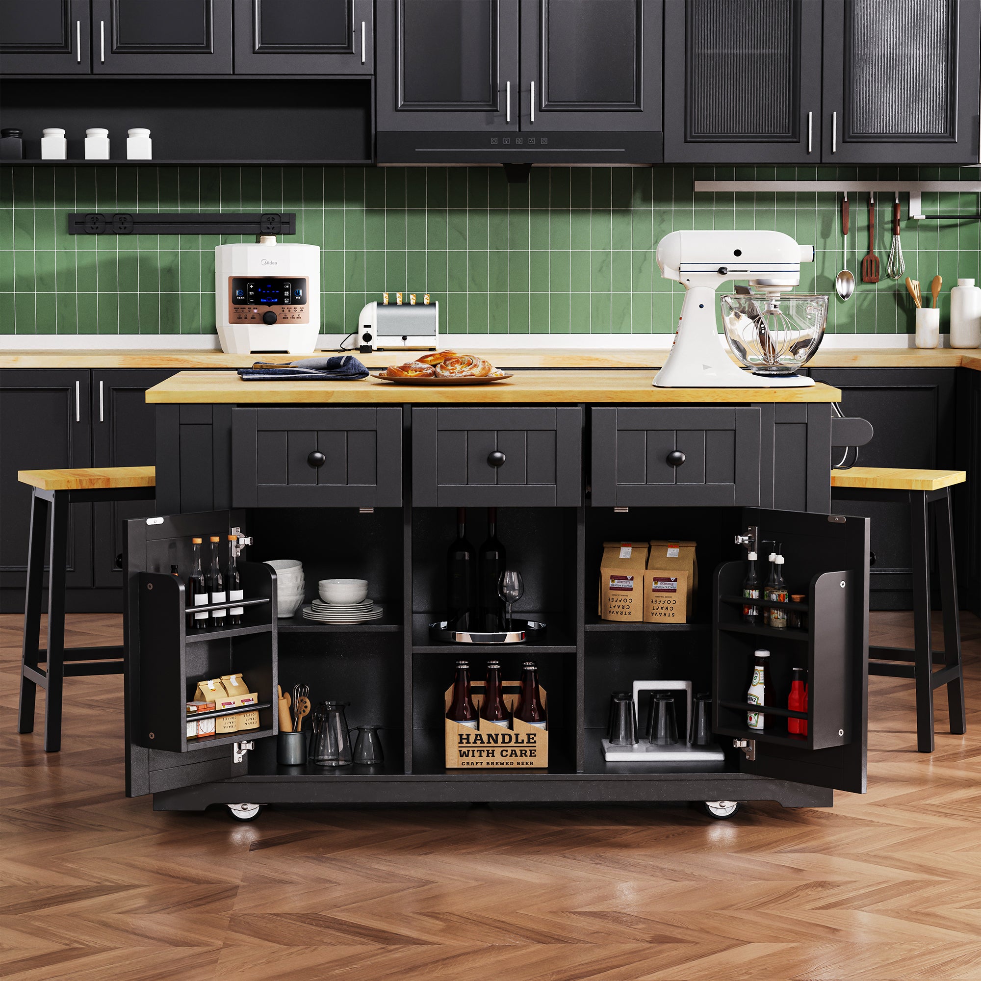 Front view of Maui black rolling kitchen island with open cabinet storage drawers door mounted spice racks matching stools and expandable countertop in modern kitchen scene