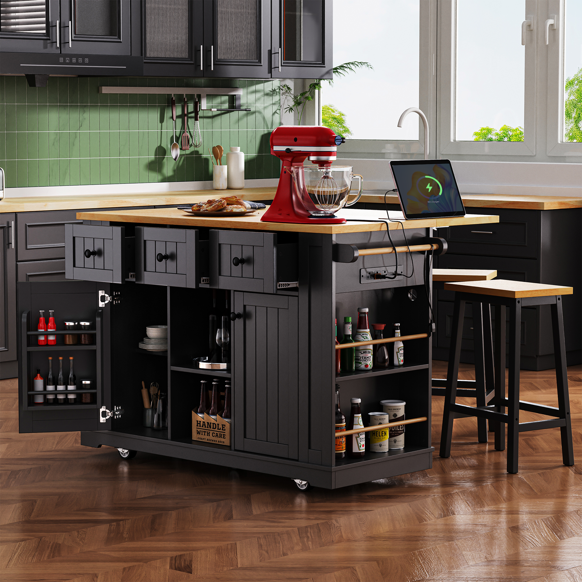 Maui black rolling kitchen island with open drawers cabinet storage side spice racks built in power outlet and matching stools in modern kitchen setting