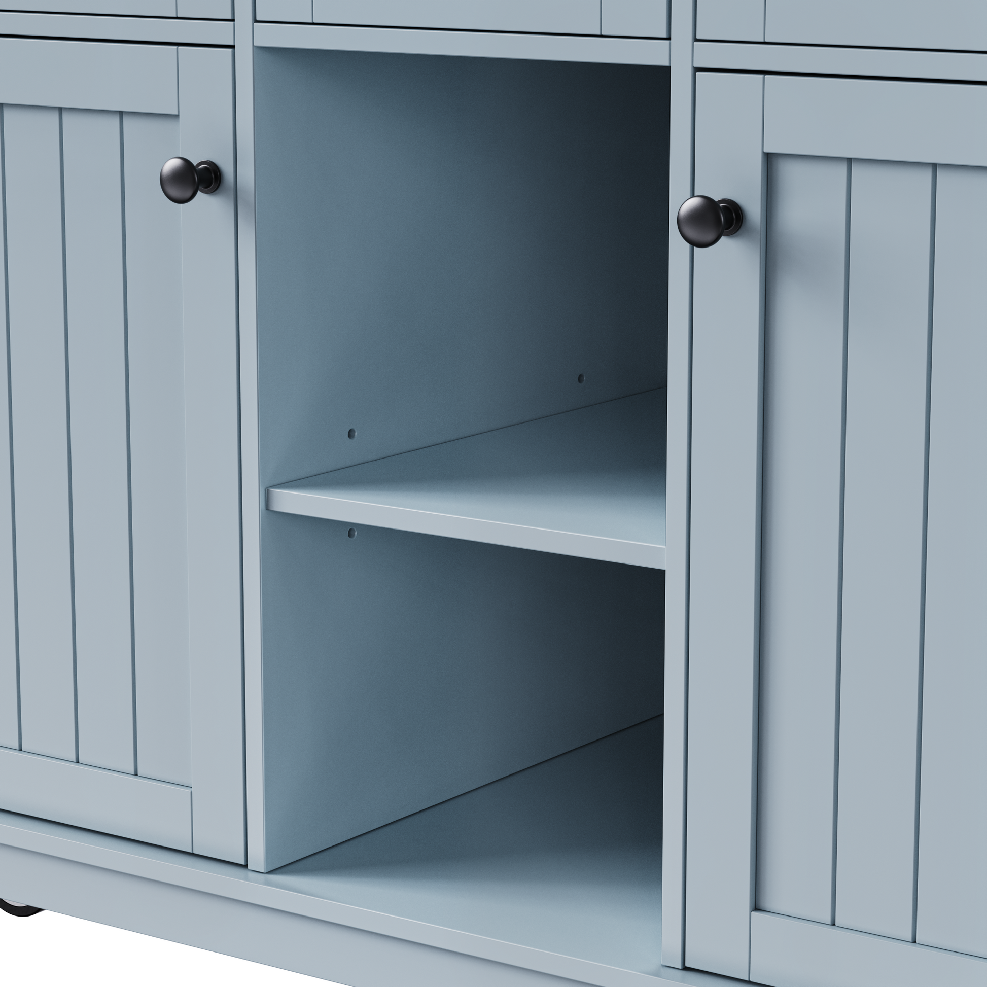 Close-up of Maui gray blue rolling kitchen island featuring adjustable open storage shelf with farmhouse cabinet doors and black round knobs