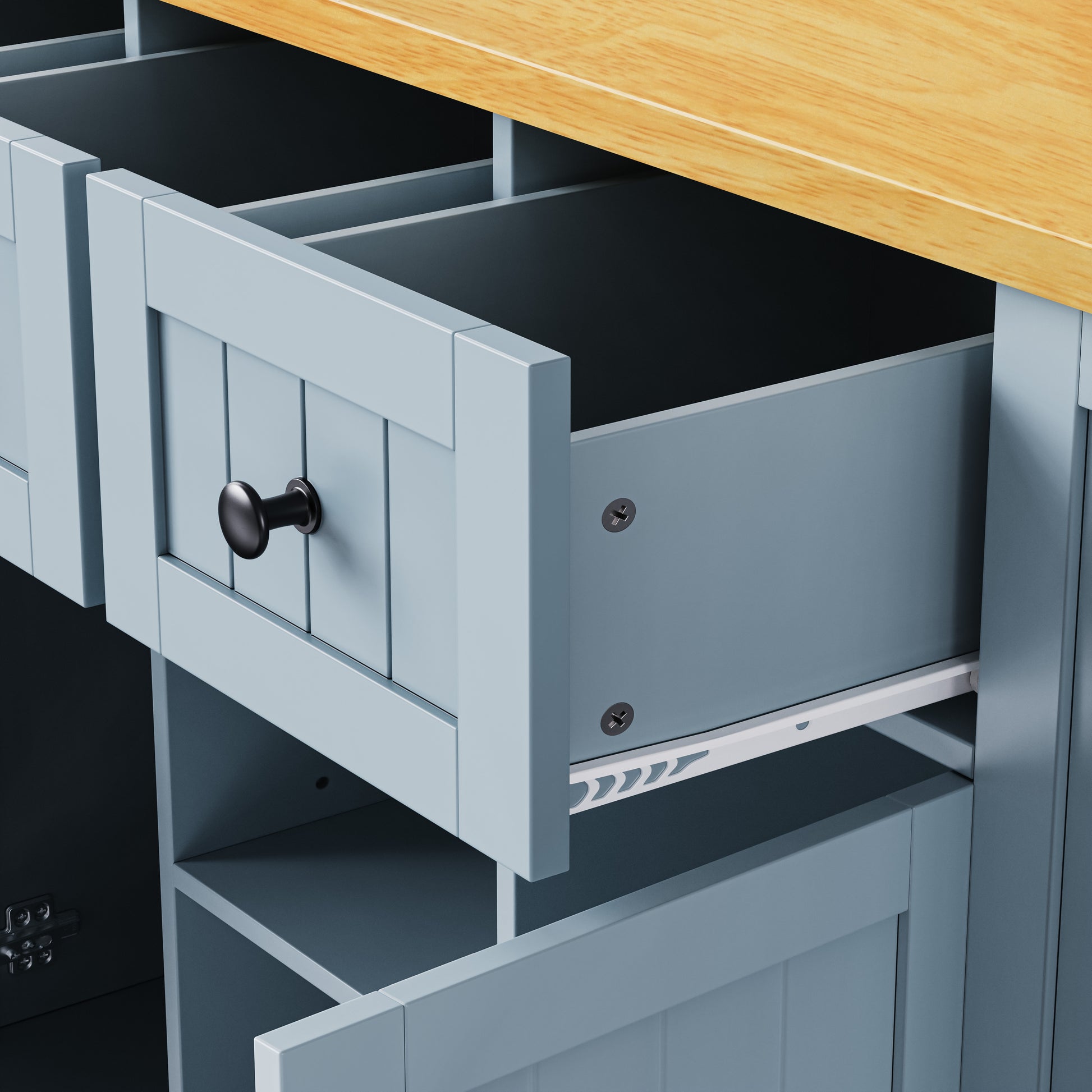 Close-up detail of Maui gray blue rolling kitchen island featuring spacious storage drawer with smooth slide rails and farmhouse panel design