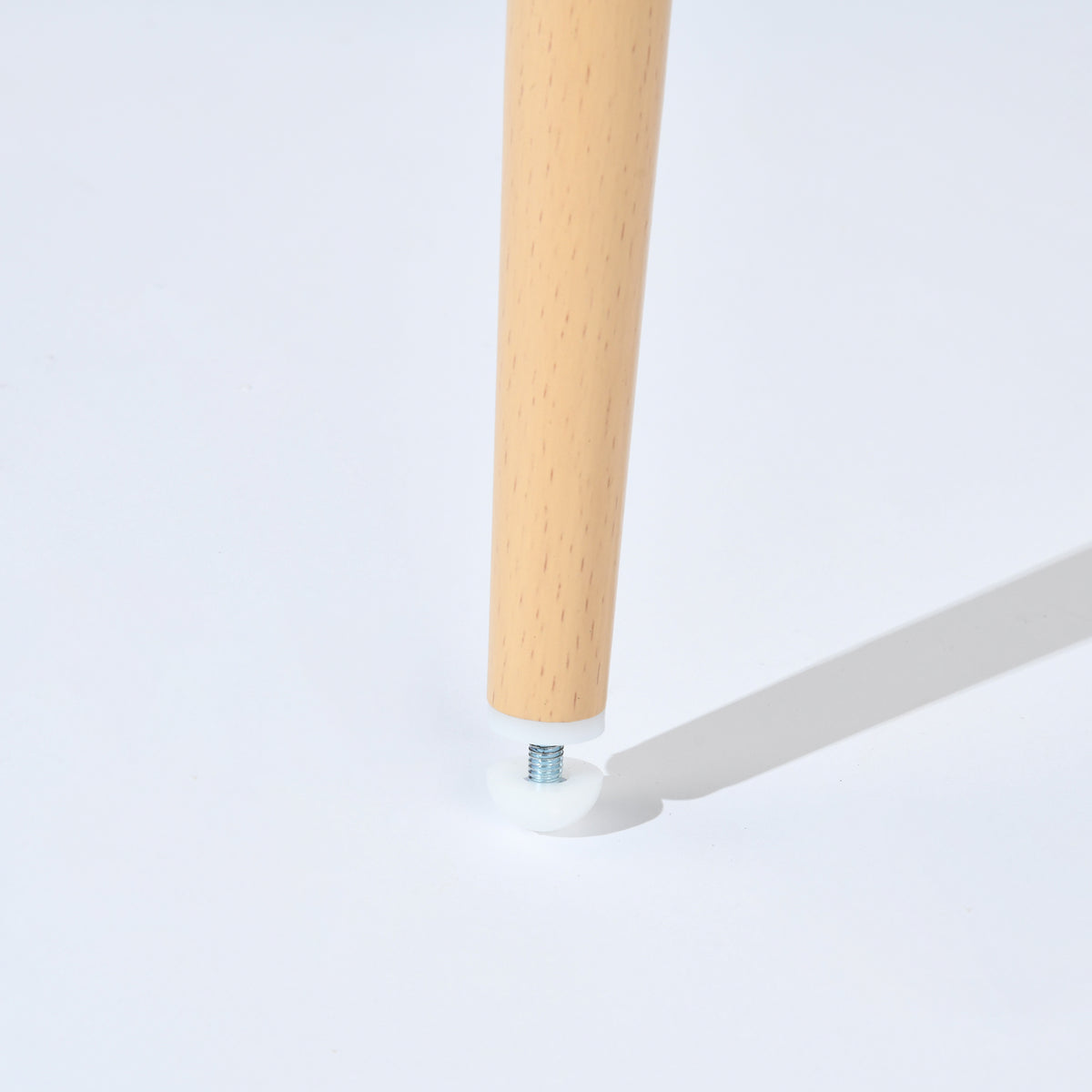 Mayfair beige dining chair showing light wood-tone leg and adjustable foot leveler detail