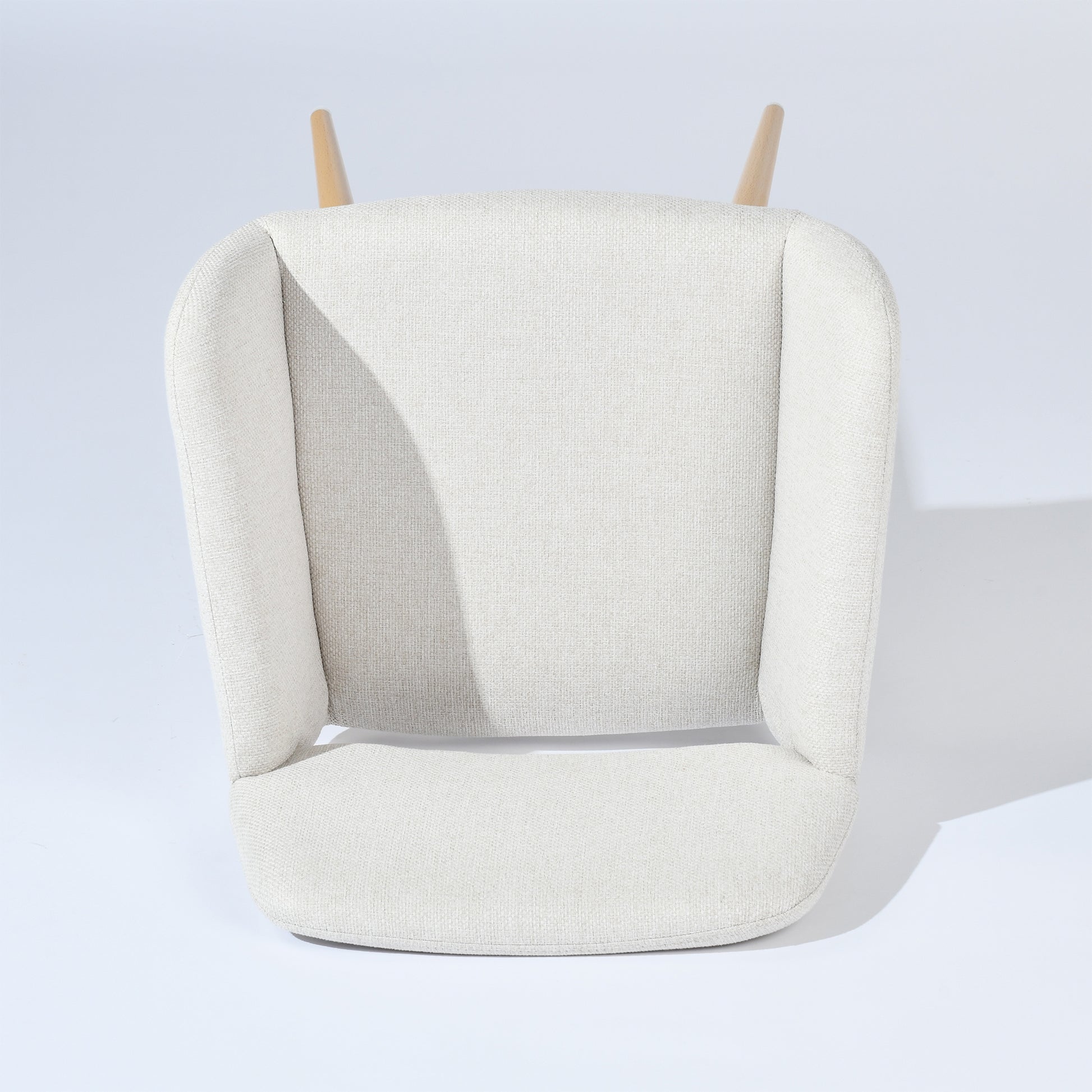 Mayfair beige fabric dining chair showing top view of the armrest and seat shape