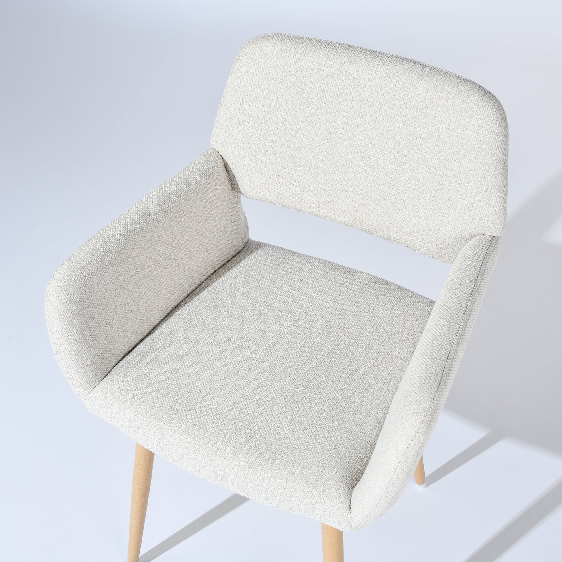 Mayfair beige fabric dining chair showing woven upholstery texture detail