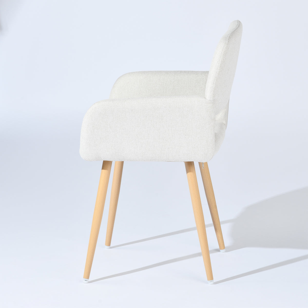 Mayfair beige fabric dining chair with armrests on white background, side view