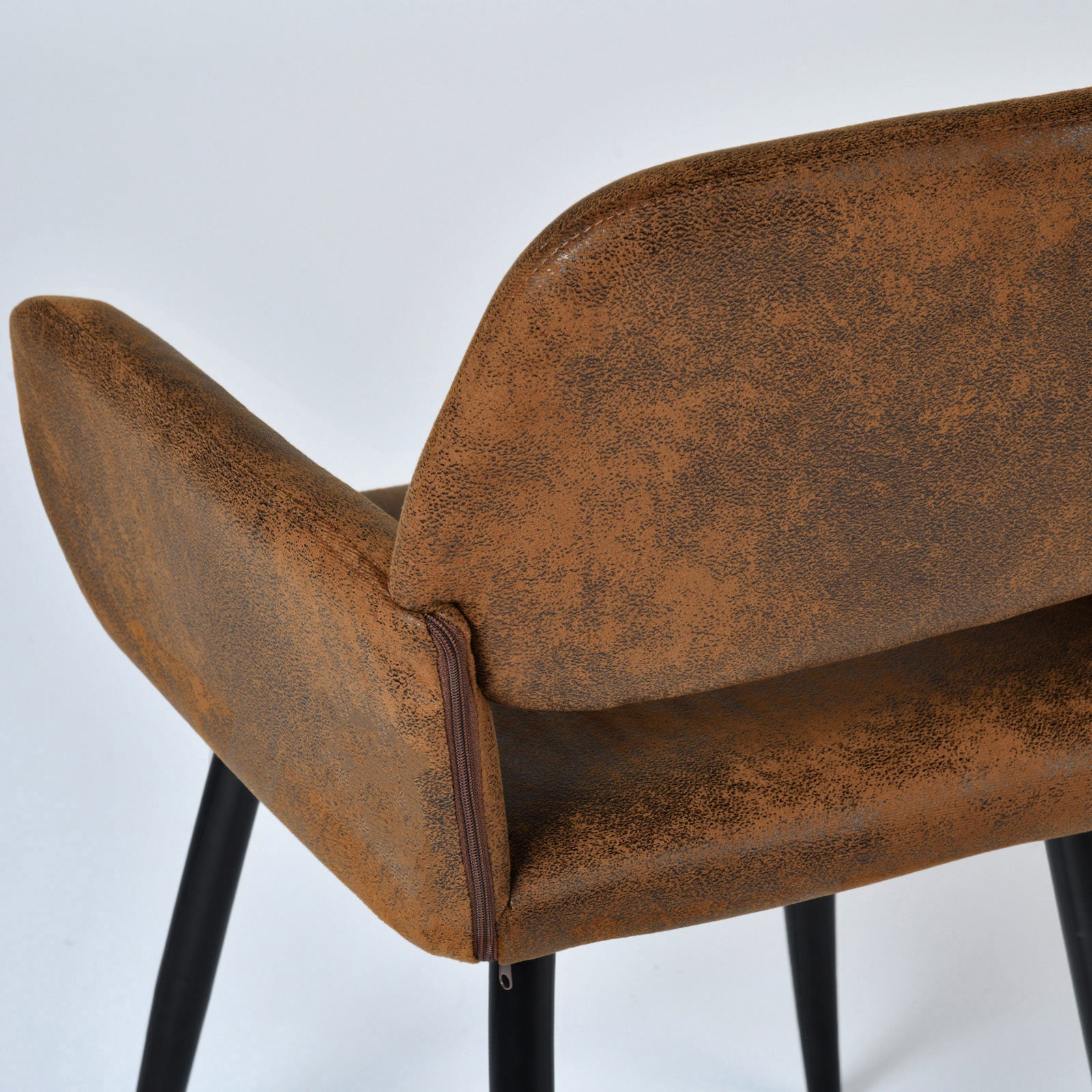 Mayfair suede brown dining chair showing curved armrest and side upholstery detail