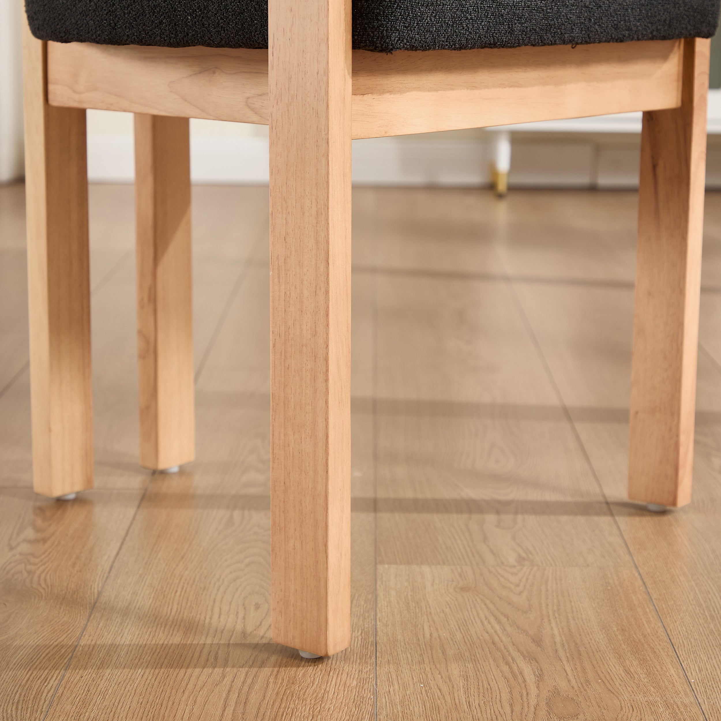 Michigan black dining chair close-up of the chair legs and lower frame on the floor