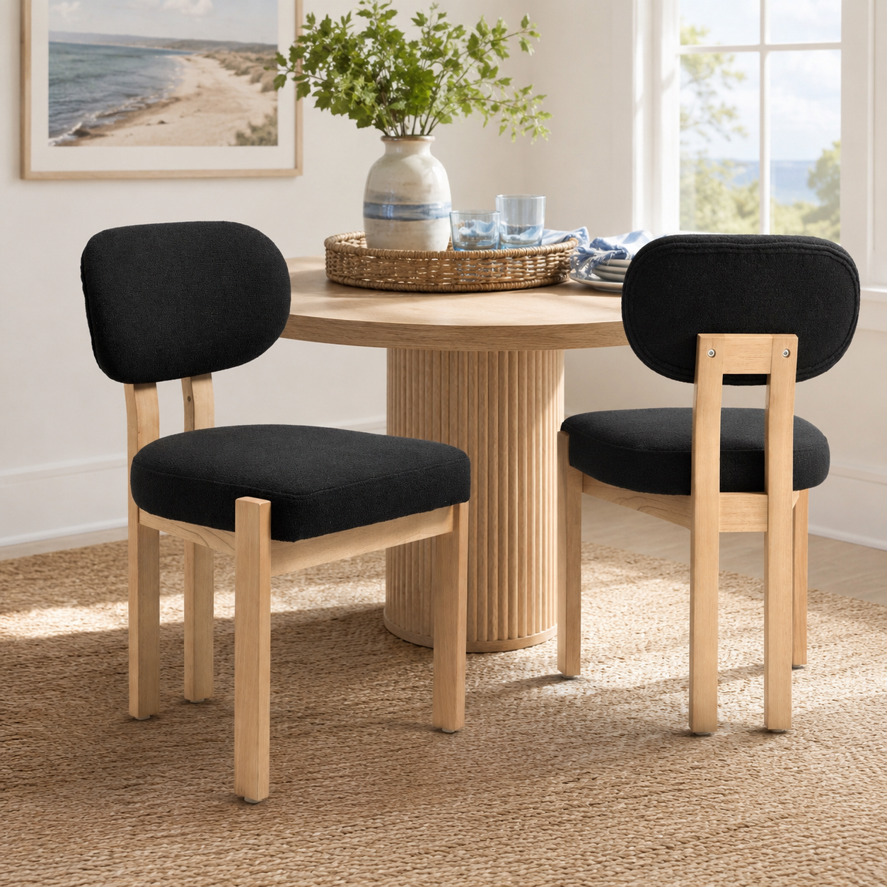 Michigan black upholstered dining chairs with solid rubberwood legs around a round wood dining table