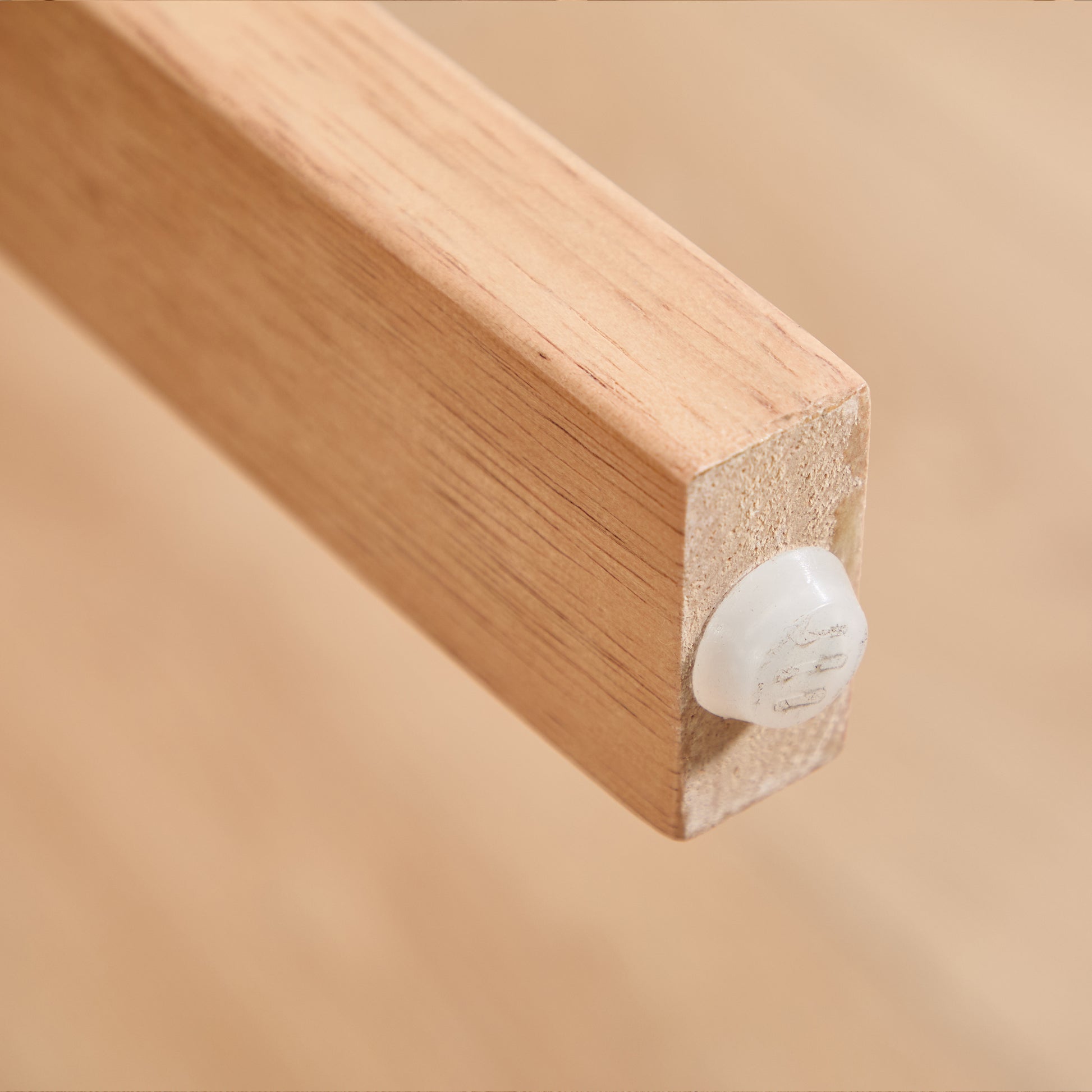 Michigan orange upholstered dining chair close-up of the solid rubberwood leg with floor protector