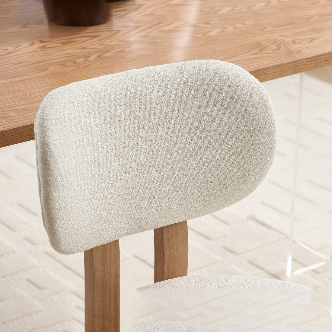Michigan white upholstered dining chair close-up of the rounded backrest and smooth fabric upholstery