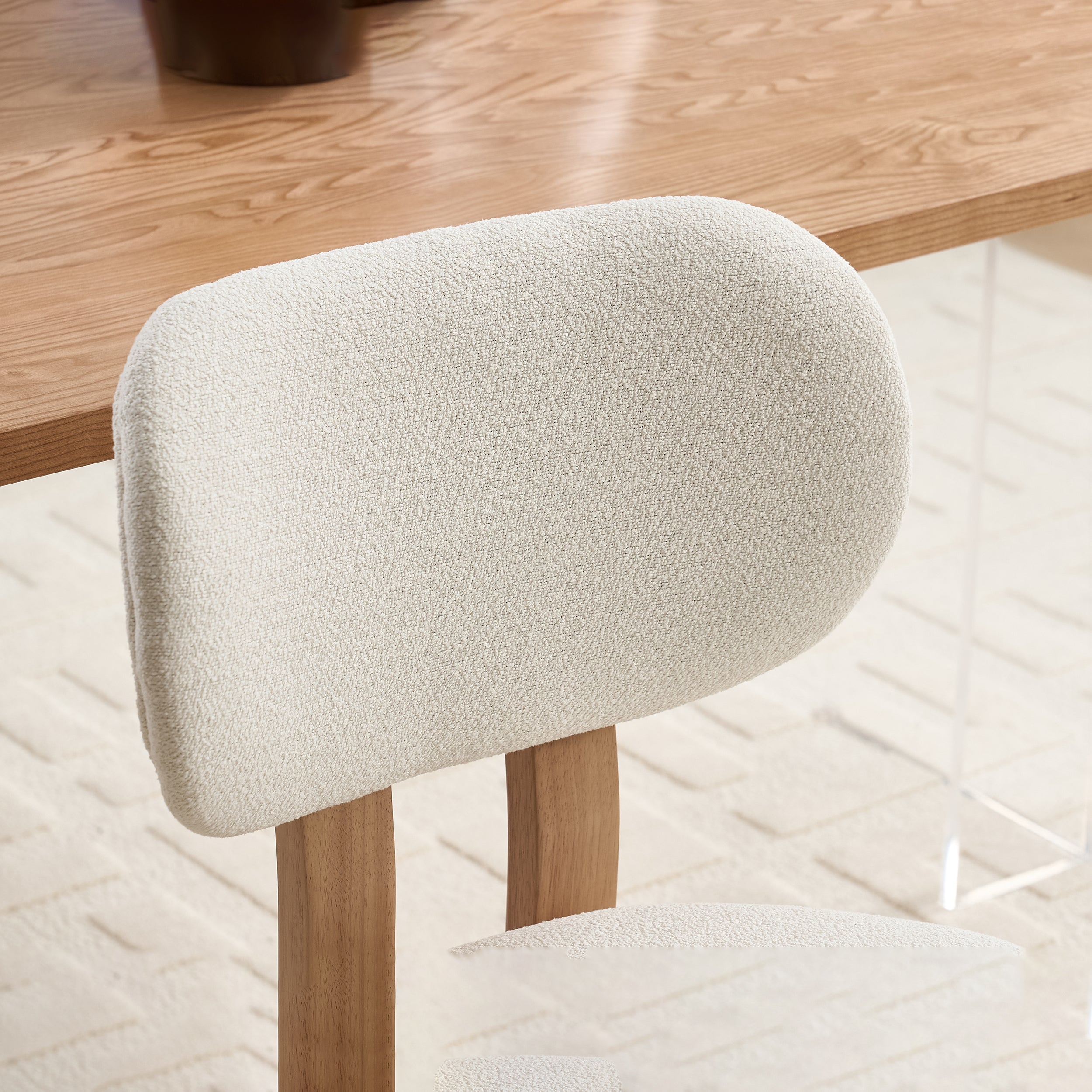Michigan white upholstered dining chair close-up of the rounded backrest and smooth fabric upholstery