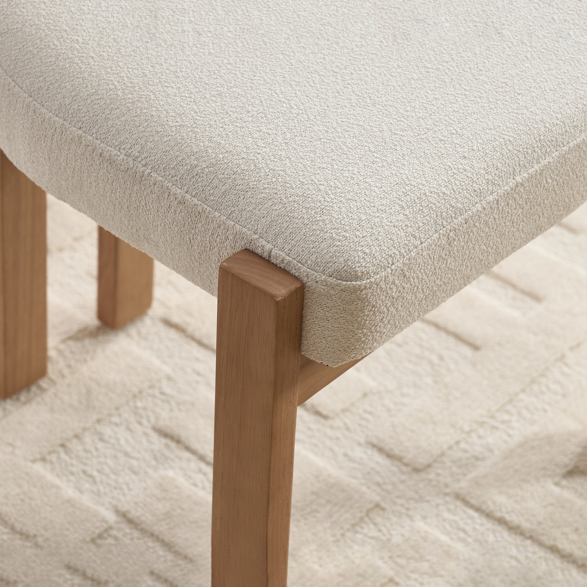 Michigan white dining chair close-up of the solid rubberwood leg and upholstered seat edge