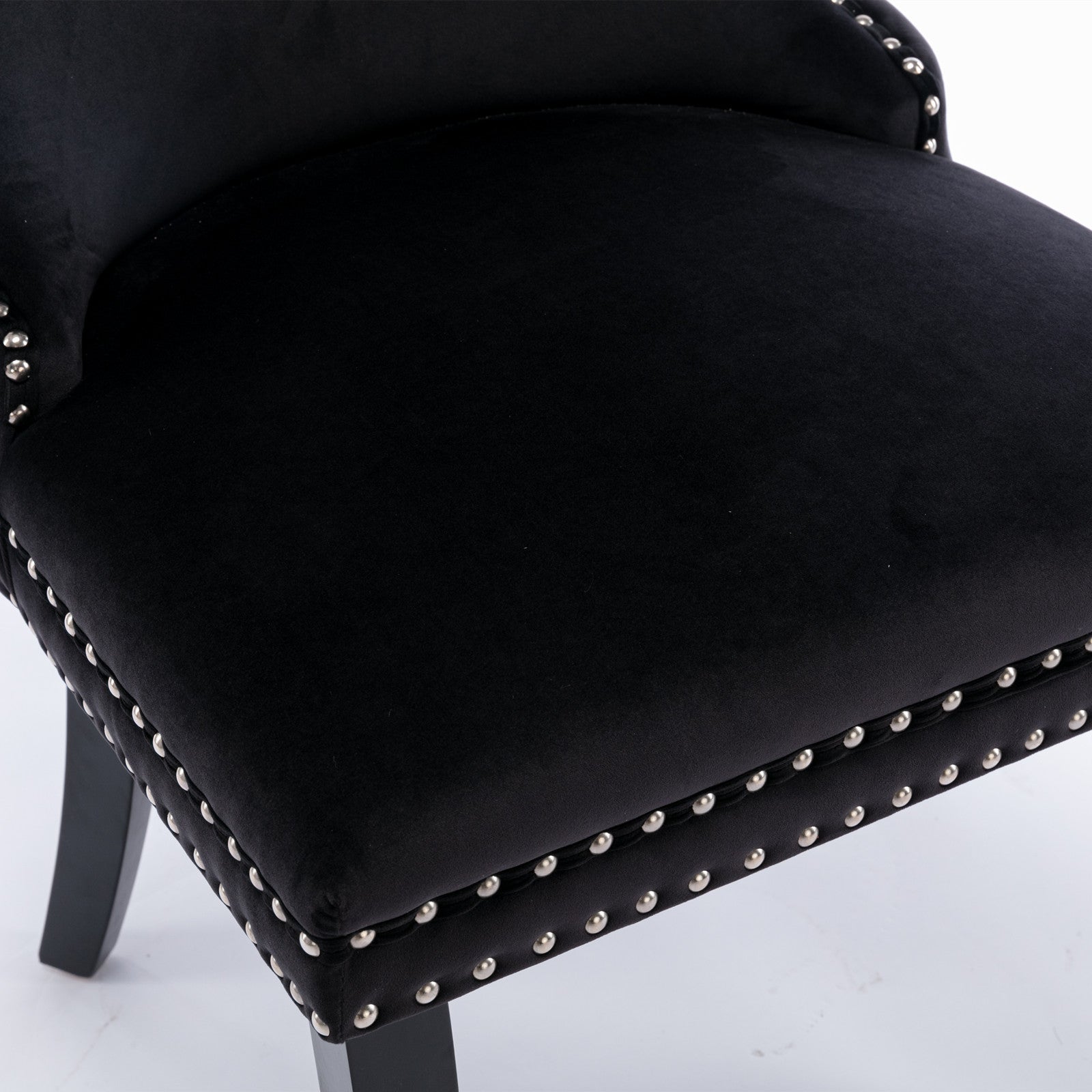 Missouri black dining chair close-up of the curved back upholstery and nailhead trim
