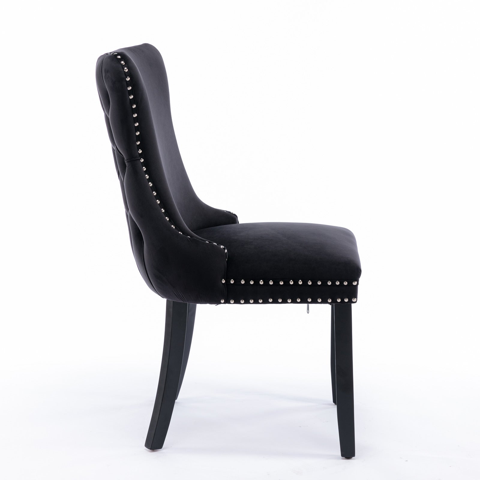 Missouri black tufted dining chair side view with solid wood legs on white background