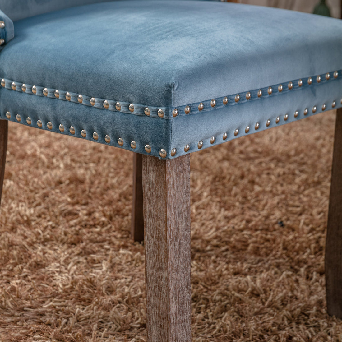 Missouri blue dining chair close-up of the upholstered seat edge with decorative nailhead trim