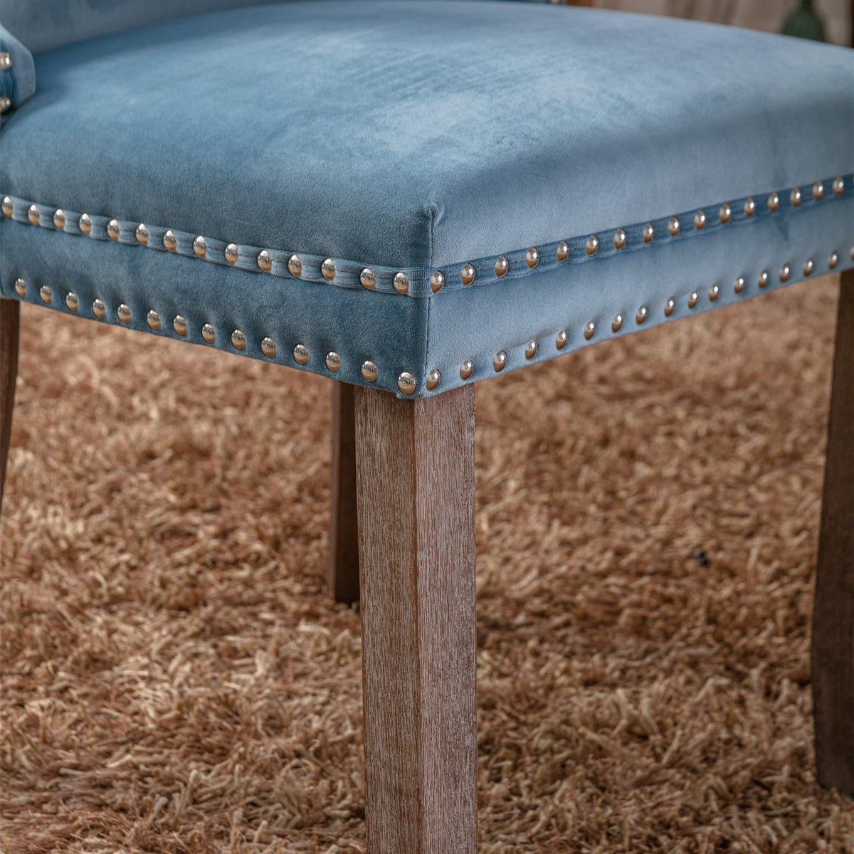 Missouri blue dining chair close-up of the upholstered seat edge with decorative nailhead trim